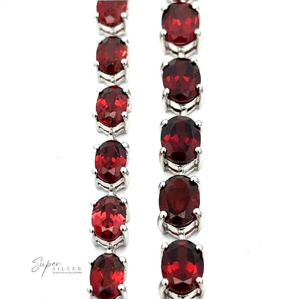 
                  
                    Rows of oval-cut red gemstones set in a Pronged Garnet Bracelet With Rhodium Finish.
                  
                