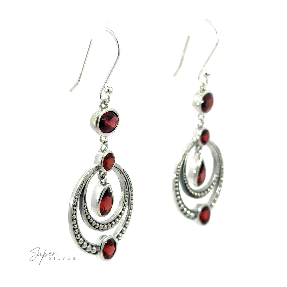 
                  
                    A pair of dazzling Overlapping Circle Earrings with Vibrant Gemstones, featuring multiple oval and round shapes, is displayed against a white background. These Bali-style earrings add a touch of exotic elegance to any ensemble.
                  
                