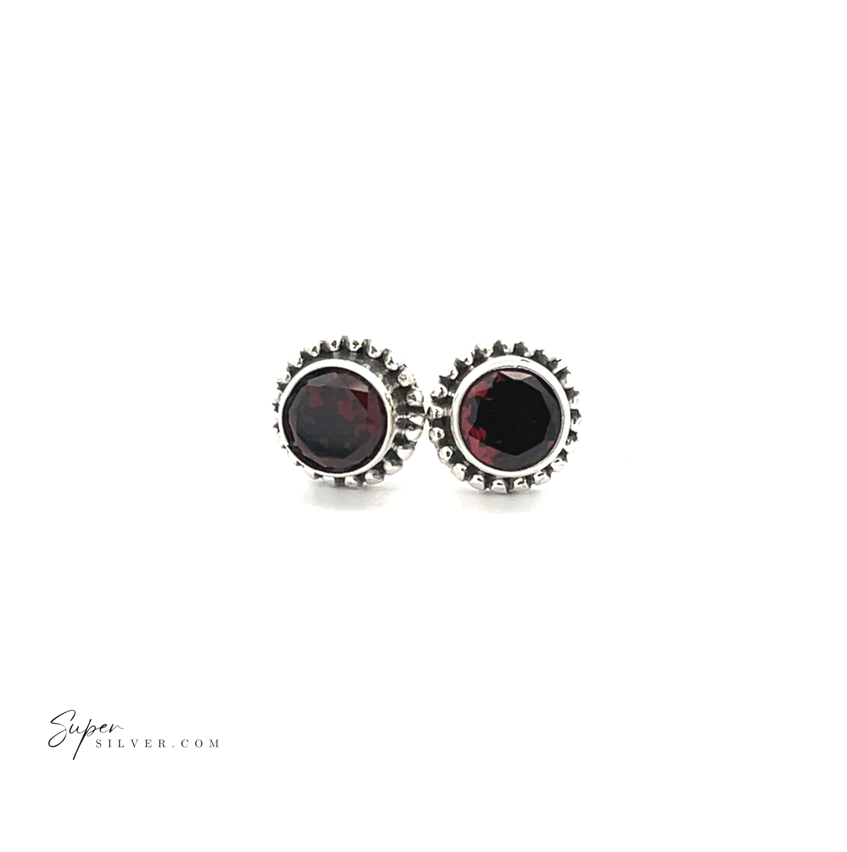 The Beaded Round Faceted Gemstone Studs are sterling silver earrings with dark red gemstone centers, displayed on a white background.