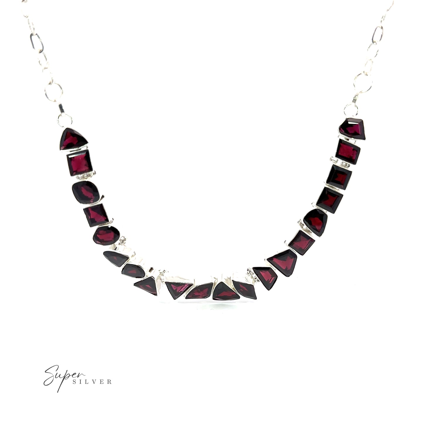 
                  
                    A Statement Gemstone Necklace featuring a series of deep red, irregularly shaped garnet stones, arranged in a curved pattern. The brand name "Super Silver" is visible in the bottom left corner.
                  
                