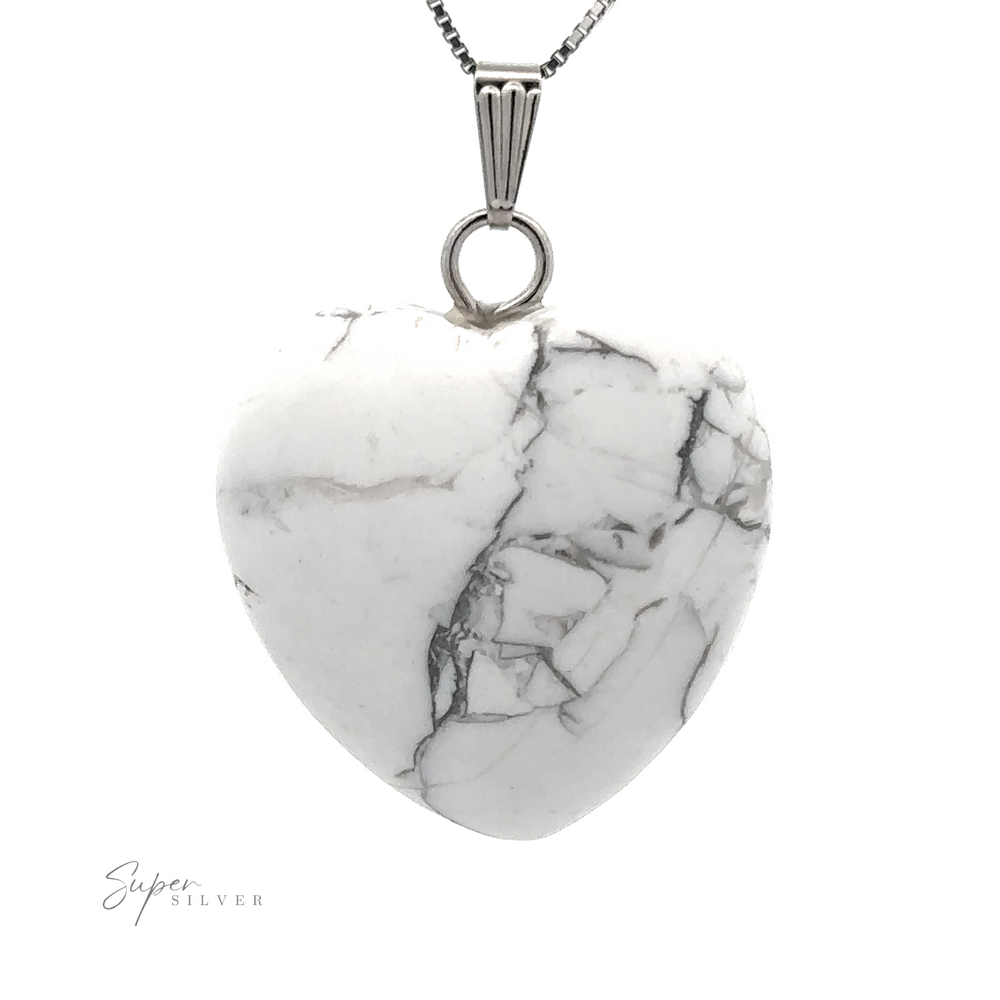 
                  
                    A Heart Stone Pendant with gray marbling veined throughout, hanging from a silver chain. Perfect for everyday wear, the stylish piece subtly blends mixed metals and features the text "Super Silver" on the bottom left corner.
                  
                