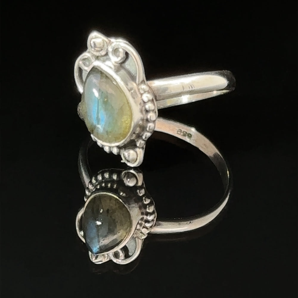
                  
                    Vintage Inspired Teardrop Gemstone Ring displayed against a dark background.
                  
                
