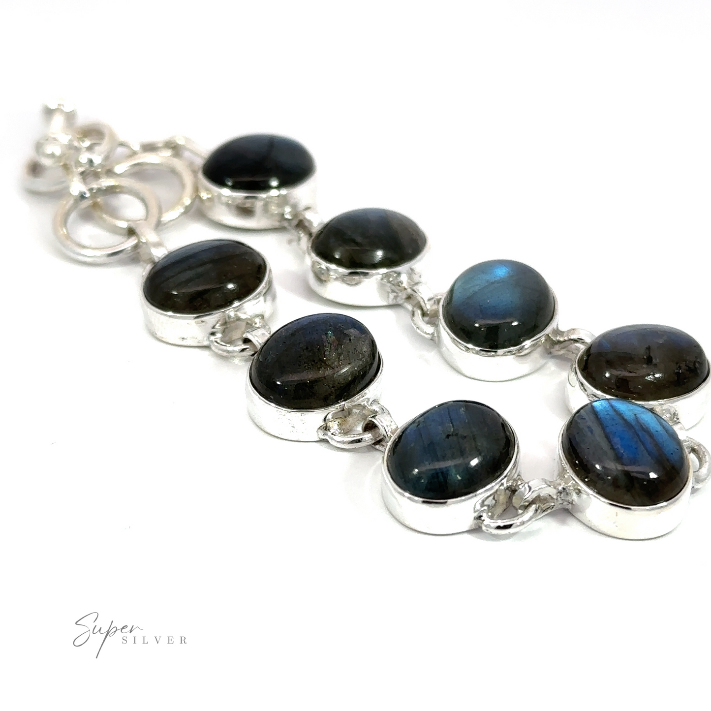 
                  
                    Statement Oval Gemstone Bracelet with oval labradorite stones, showing varying shades of blue and gray, displayed against a white background.
                  
                
