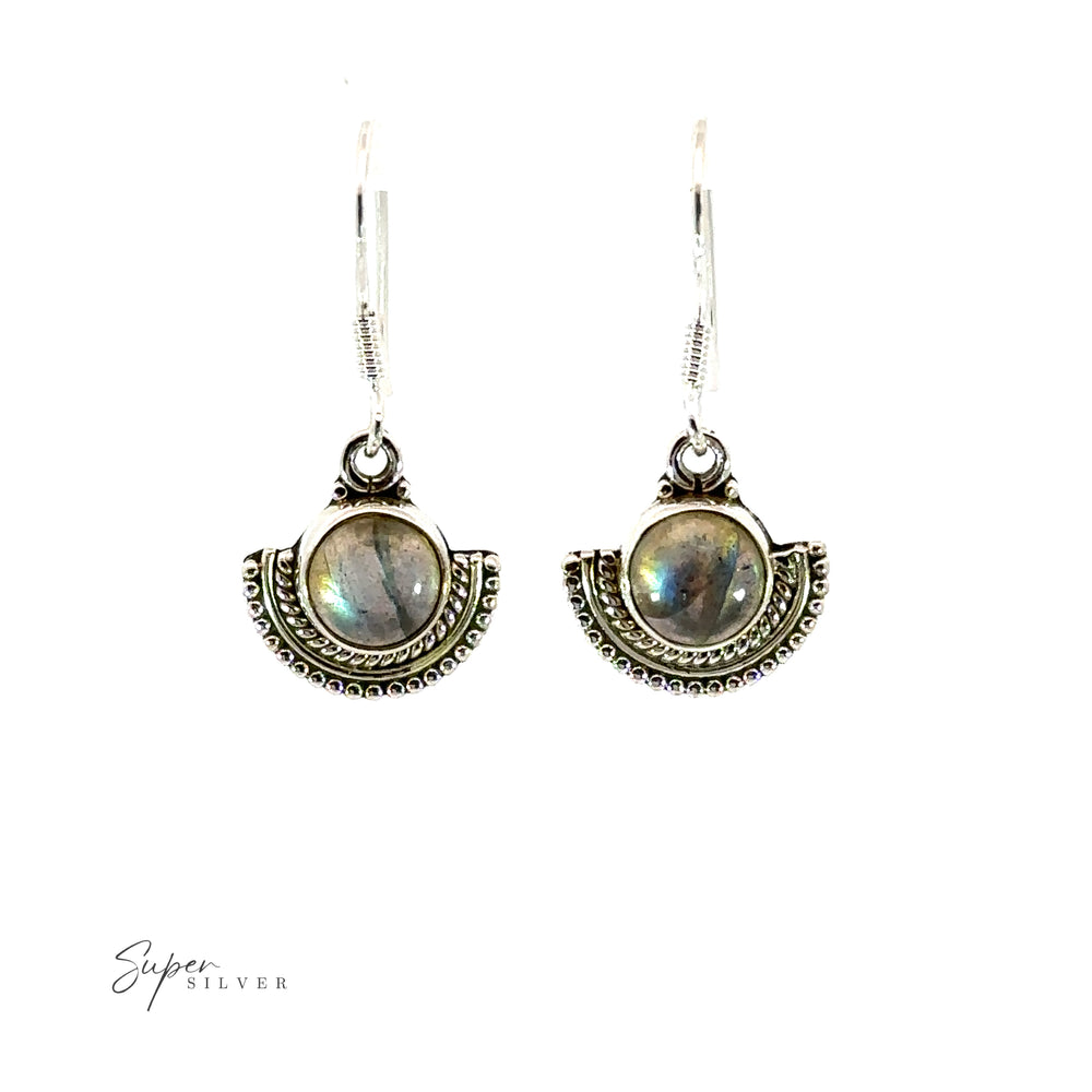 
                  
                    Round gemstone earrings with a labradorite stone in a silver fan-like setting.
                  
                