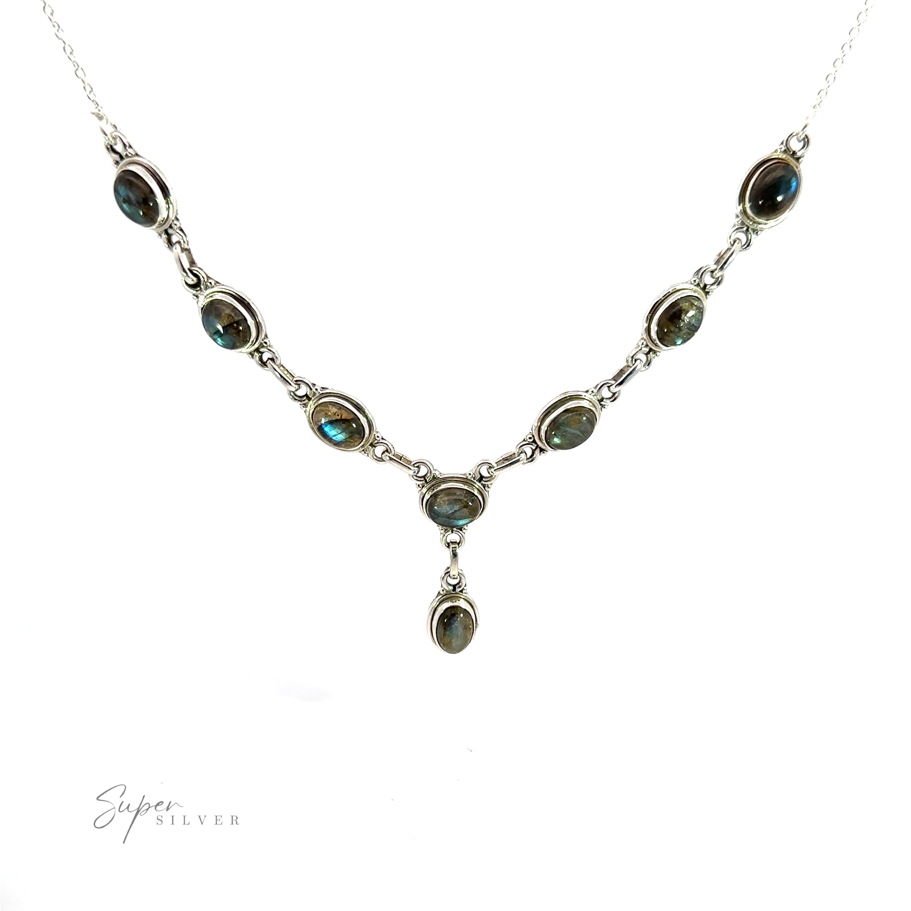A Simple Oval Y Necklace with Gemstones featuring nine oval gemstones linked together with silver chains forming a symmetrical pattern, displayed against a white background, exuding a touch of bohemian charm.