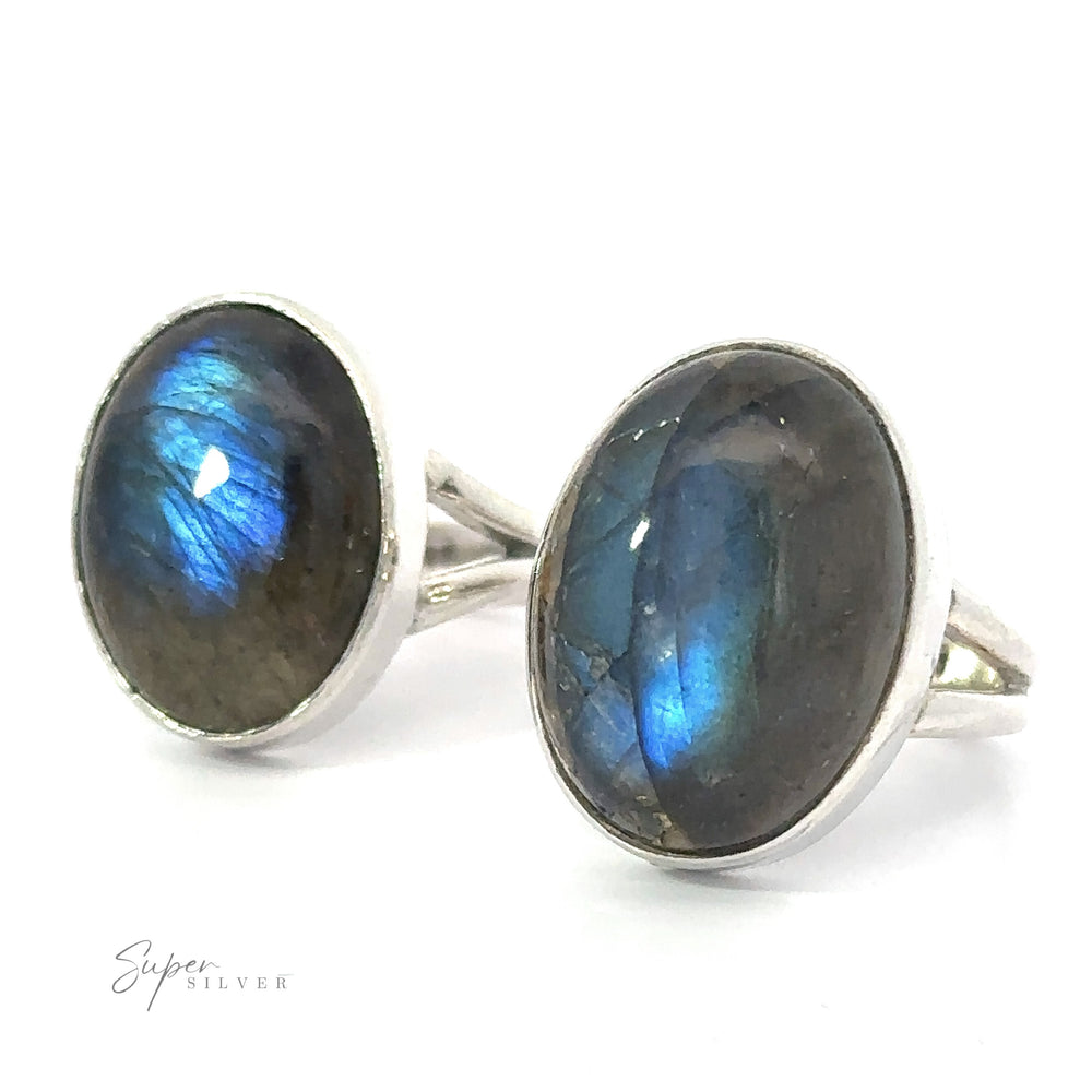 Two Heavy Oval Labradorite Rings with prominent blue iridescence displayed against a white background.