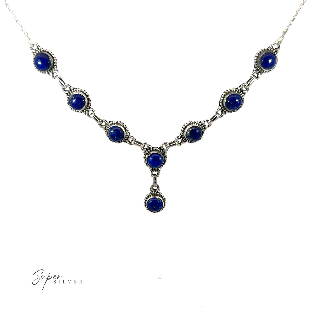 
                  
                    This Round Gemstone Y Necklace with Ball Border features a symmetrical design with multiple round blue gemstones and an additional gemstone hanging from the center, embodying the essence of bohemian style jewelry.
                  
                