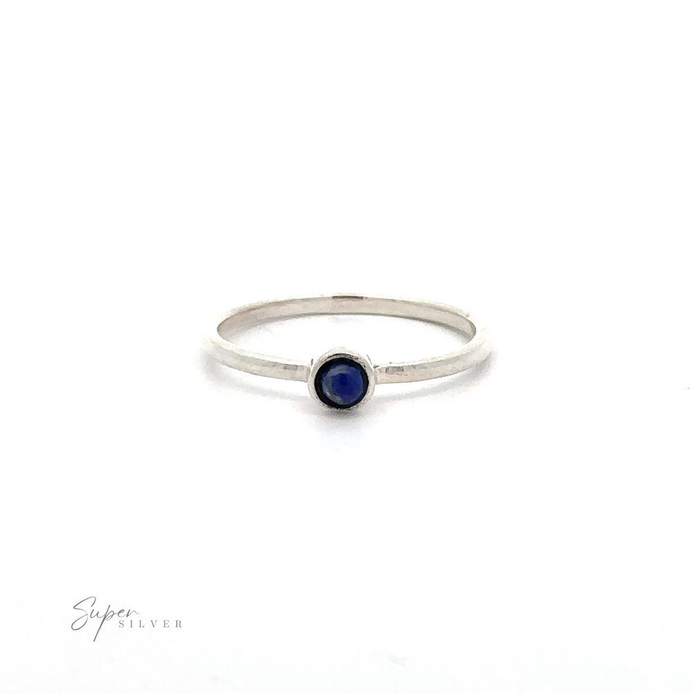 
                  
                    A thin Dainty Stackable Round Gemstone Ring with a small, round, blue gemstone in the center. The brand name "Super Silver" is faintly visible in the bottom left corner. Perfect for those who adore minimalist fashion and stackable rings.
                  
                