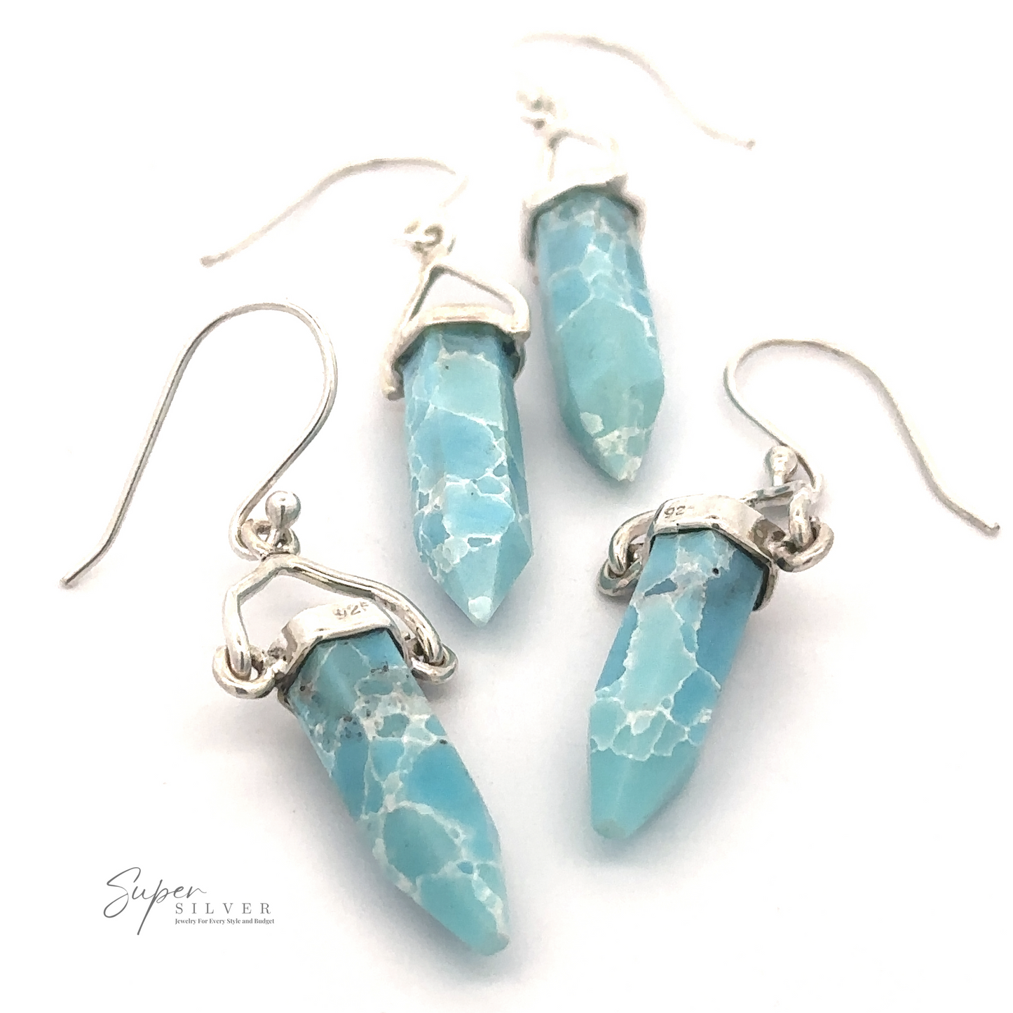 
                  
                    A pair of Obelisk Shape Raw Larimar Earrings in sterling silver settings, displayed on a white background with the "Super Silver" logo in the corner.
                  
                
