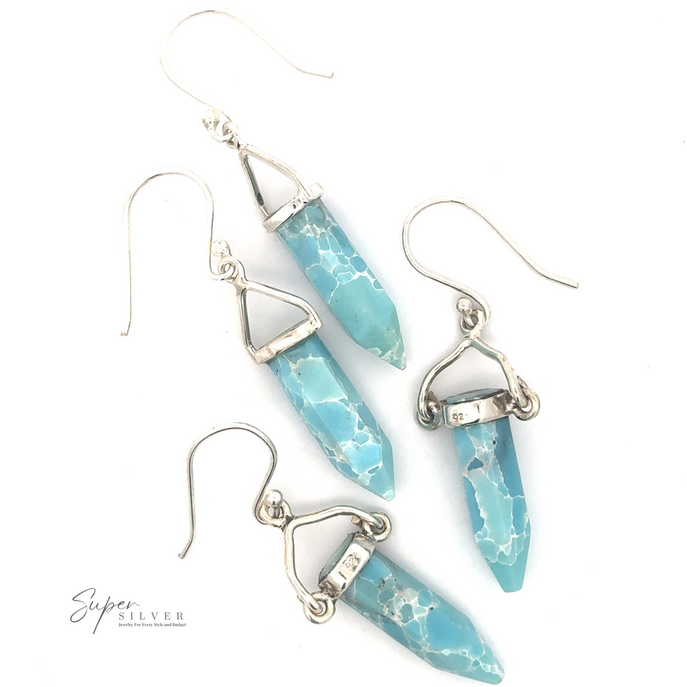 
                  
                    A pair of Obelisk Shape Raw Larimar Earrings featuring blue Larimar stone pendants and elegant French hooks.
                  
                