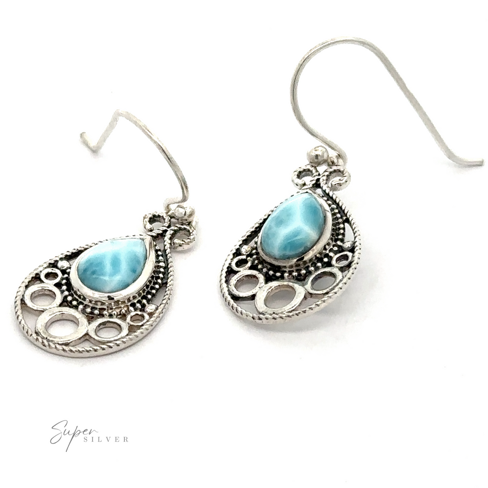 
                  
                    Teardrop Larimar Earrings with intricate designs featuring teardrop-shaped blue gemstone accents, displayed against a plain white background.
                  
                