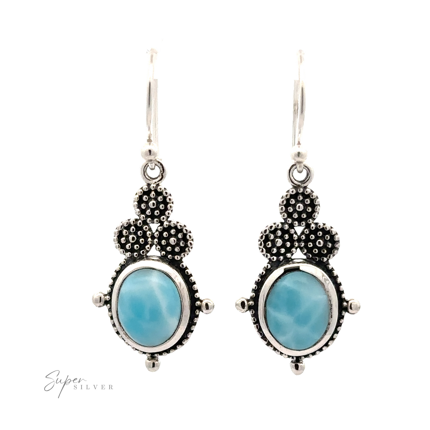 
                  
                    A pair of Beaded Oval Larimar Dangle Earrings with blue oval Larimar stones set in detailed sterling silver designs, featuring a small cluster of textured silver dots at the top and an inscription "Super Silver" at the bottom left.
                  
                