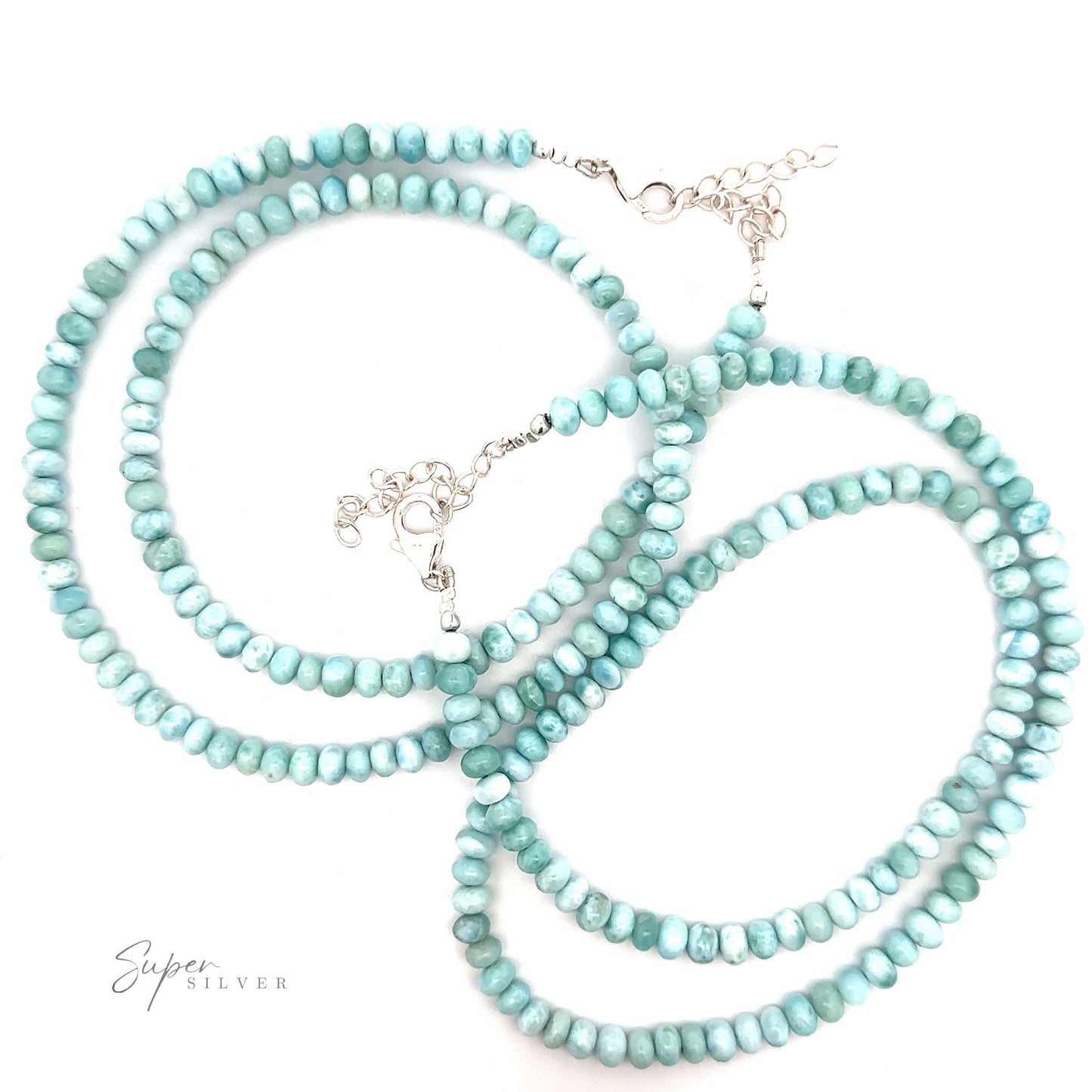
                  
                    A turquoise beaded necklace with small, round beads and silver clasps arranged in loops against a white background, reminiscent of a Larimar Beaded Necklace.
                  
                
