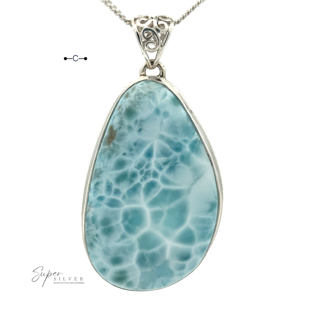 
                  
                    A Freeform Large Larimar Pendant with a white pattern, encased in a sterling silver frame and hanging on a silver chain, set against a white background. Text on the bottom left reads "Super Silver.
                  
                