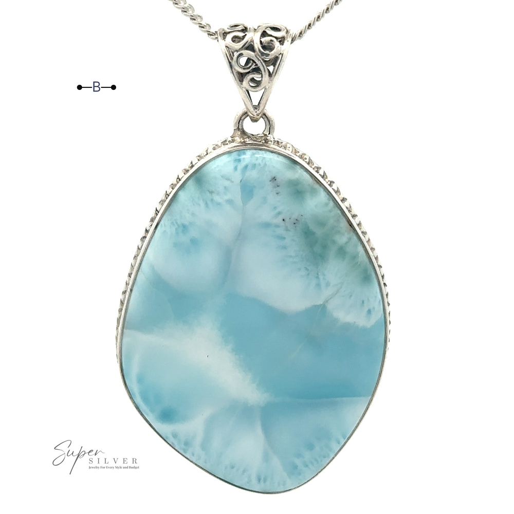 
                  
                    Close-up of a sterling silver necklace featuring a stunning blue and white Freeform Large Larimar Pendant. The gemstone showcases an irregular, teardrop-like shape with intricate filigree detailing at the top.
                  
                
