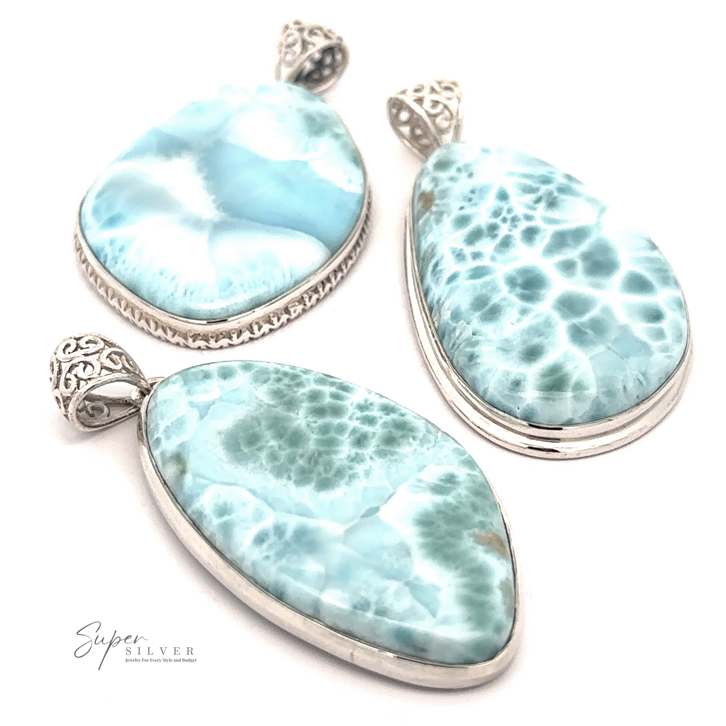 
                  
                    Three Freeform Large Larimar Pendants with intricate sterling silver settings are displayed against a white background. The stones vary in shape, including oval, teardrop, and freeform Larimar designs.
                  
                