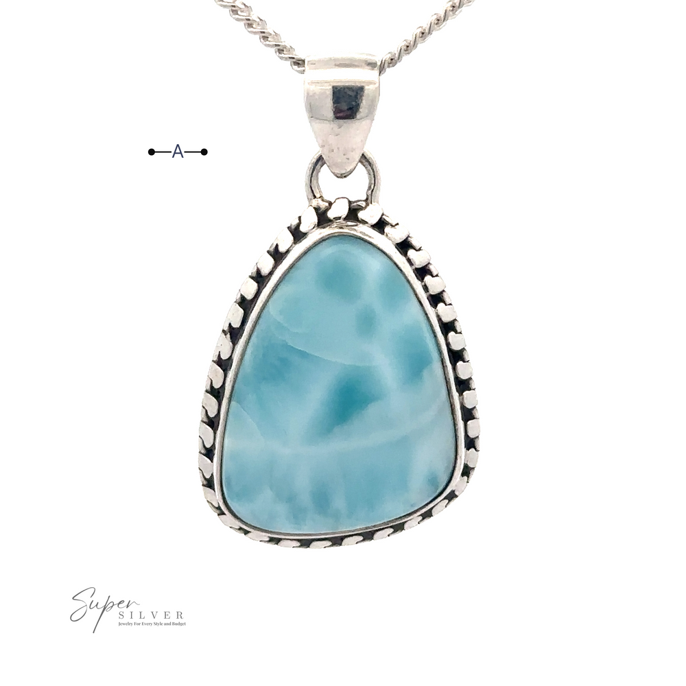 
                  
                    A triangular Larimar Pendant with Decorated Border set in .925 Sterling Silver with a wavy blue and white pattern. The pendant features a small loop at the top for attaching to your choice of chain (chain not included).
                  
                