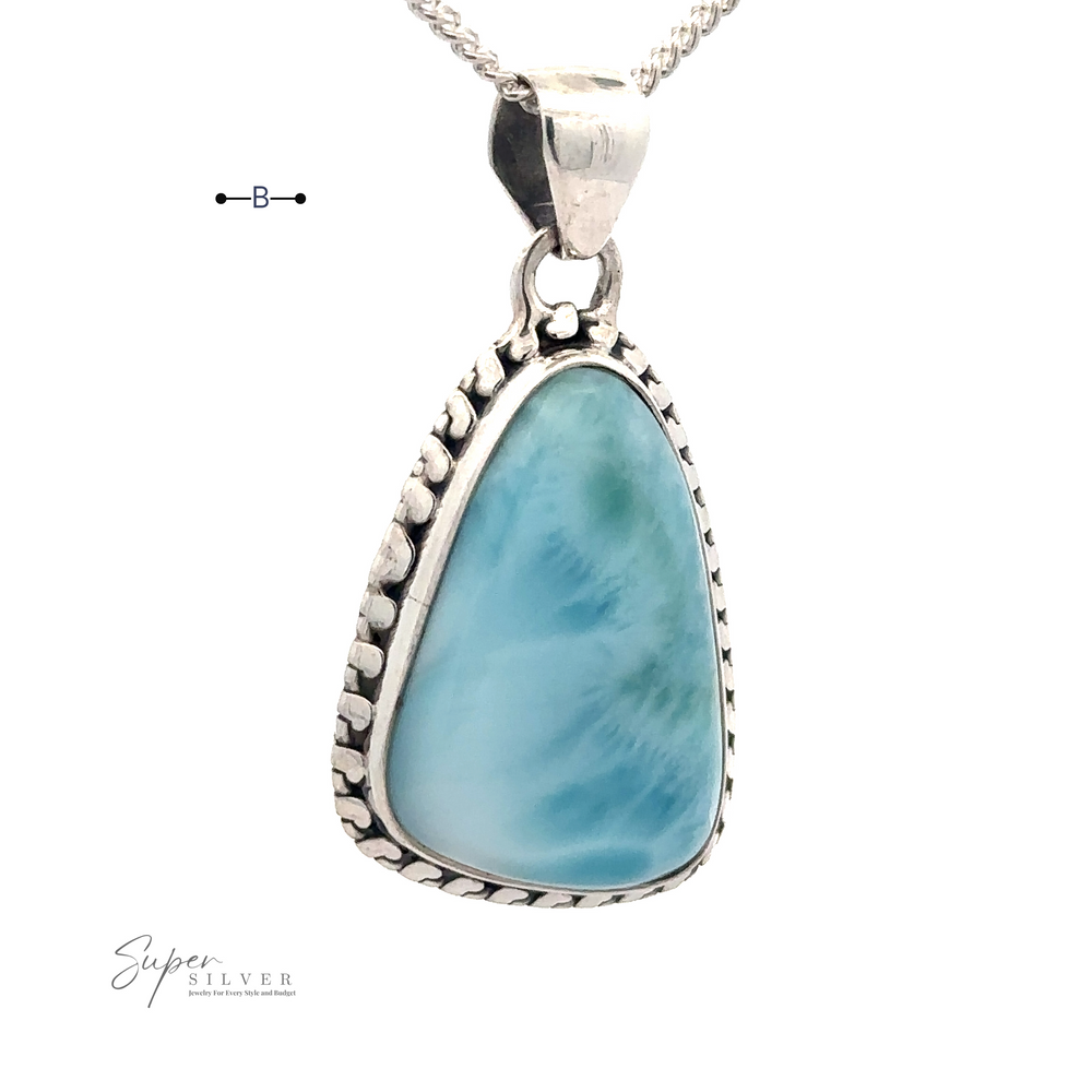 
                  
                    A silver pendant necklace featuring a large, triangular blue Larimar stone with a textured .925 Sterling Silver border. The stone has a marble-like appearance, and the chain is a simple silver link design (chain not included). It is called the Larimar Pendant with Decorated Border.
                  
                