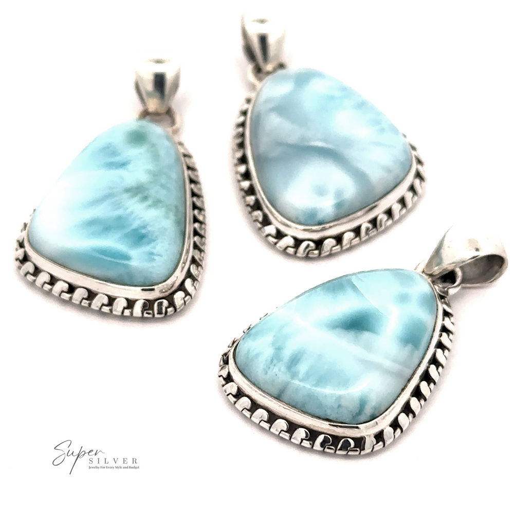 Three silver-framed, teardrop-shaped Larimar Pendants with Decorated Border featuring blue, marbled Larimar stones. The logo 