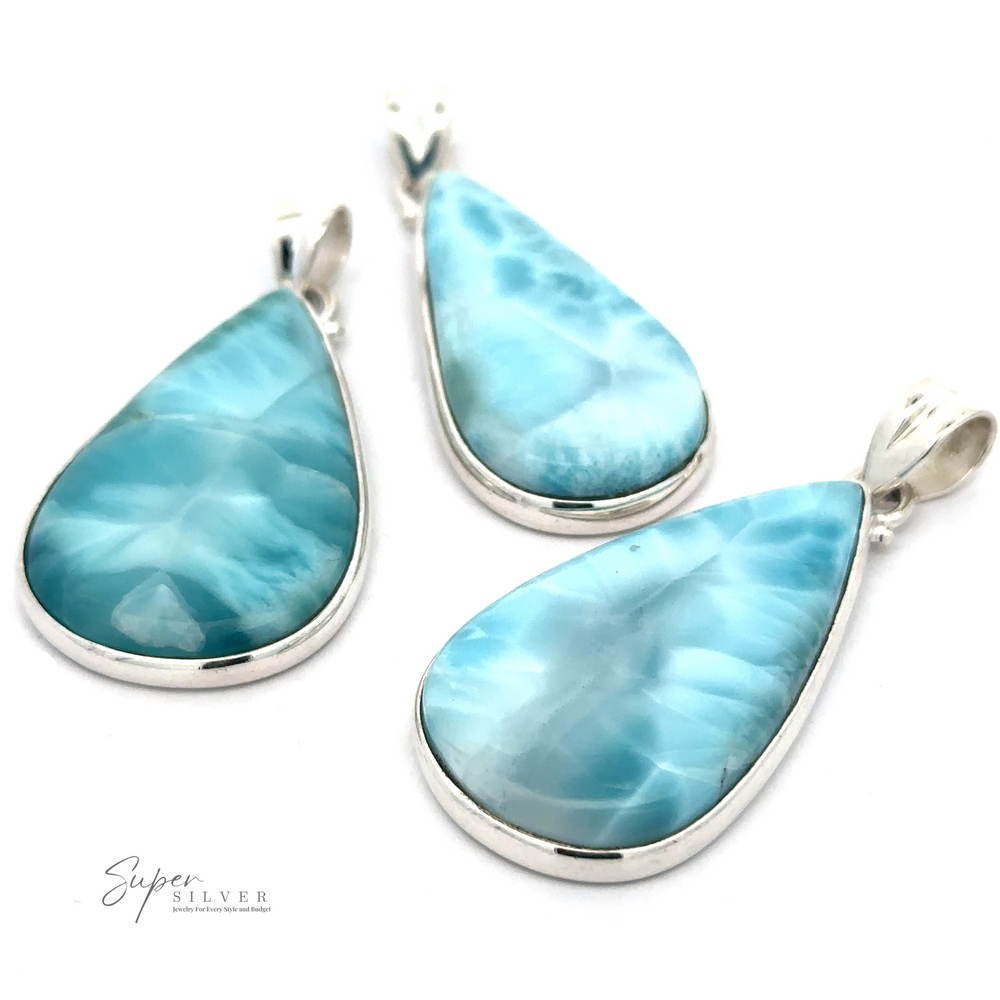 Three Larger Teardrop Larimar Pendants encased in Sterling Silver settings are displayed against a white background. The blue and white marbled stones feature unique patterns and are labeled "Super Silver.