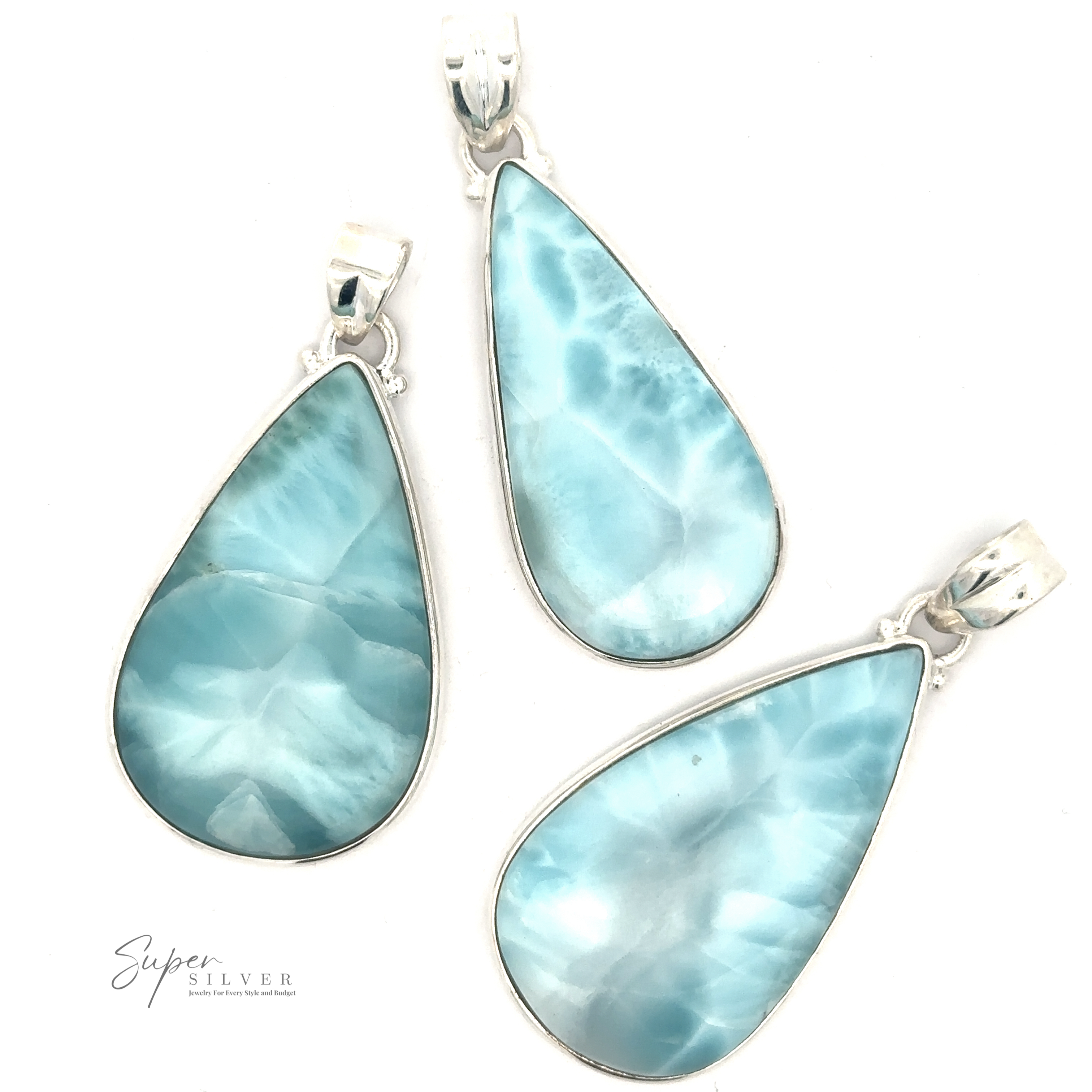 Three Larger Teardrop Larimar Pendants, each set in sterling silver, are displayed on a white background. The pendants feature various shades of blue with natural marbling patterns.