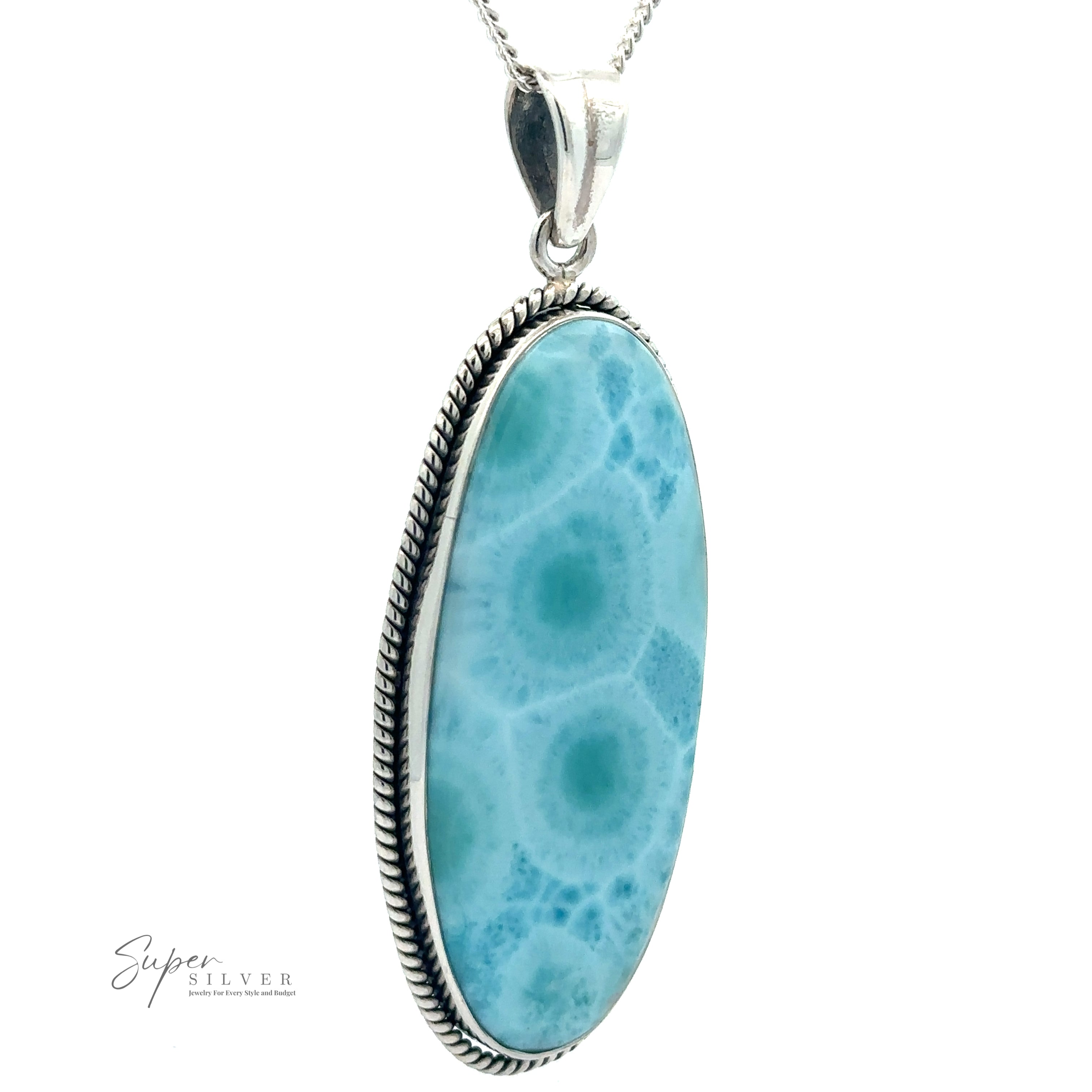 A pendant necklace featuring an oval-shaped Larimar stone with a decorative sterling silver border. The chain is thin and silver. The "Oblong Larimar Pendant with Rope Border" logo is visible in the bottom left corner, making this piece a standout example of statement jewelry.