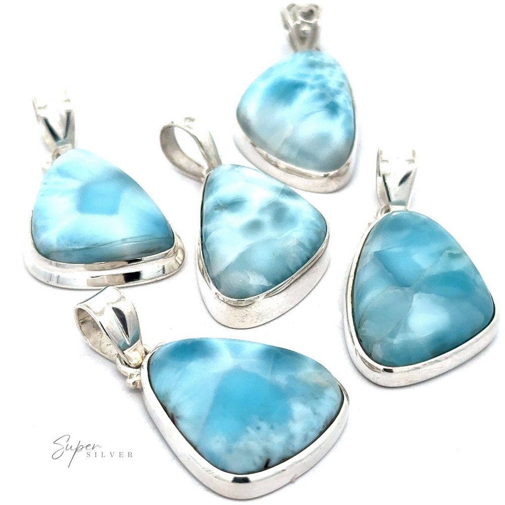 Five Freeform Shape Larimar Pendants featuring blue and white marbled Larimar stones arranged on a white background. 