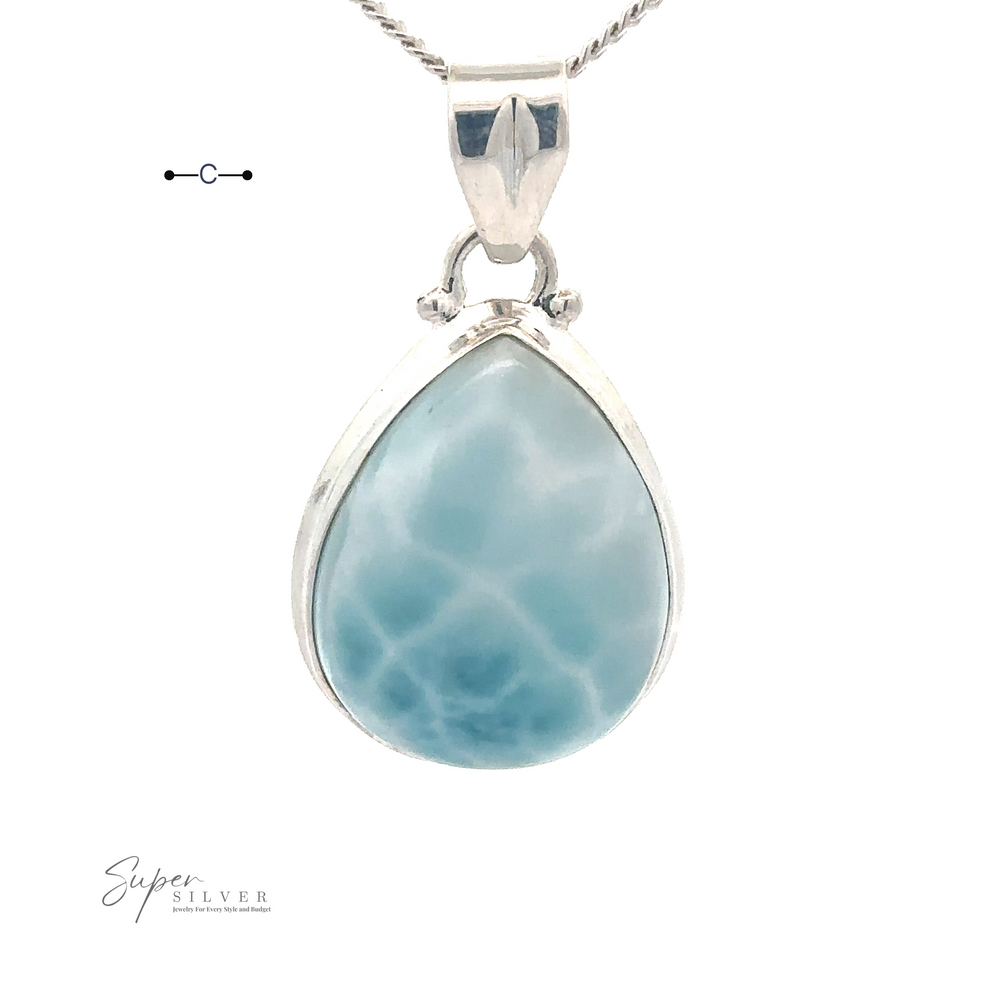 
                  
                    A Small Teardrop Larimar Pendant with a sterling silver border and chain, branded "Super Silver" at the bottom left—perfect for a night out.
                  
                