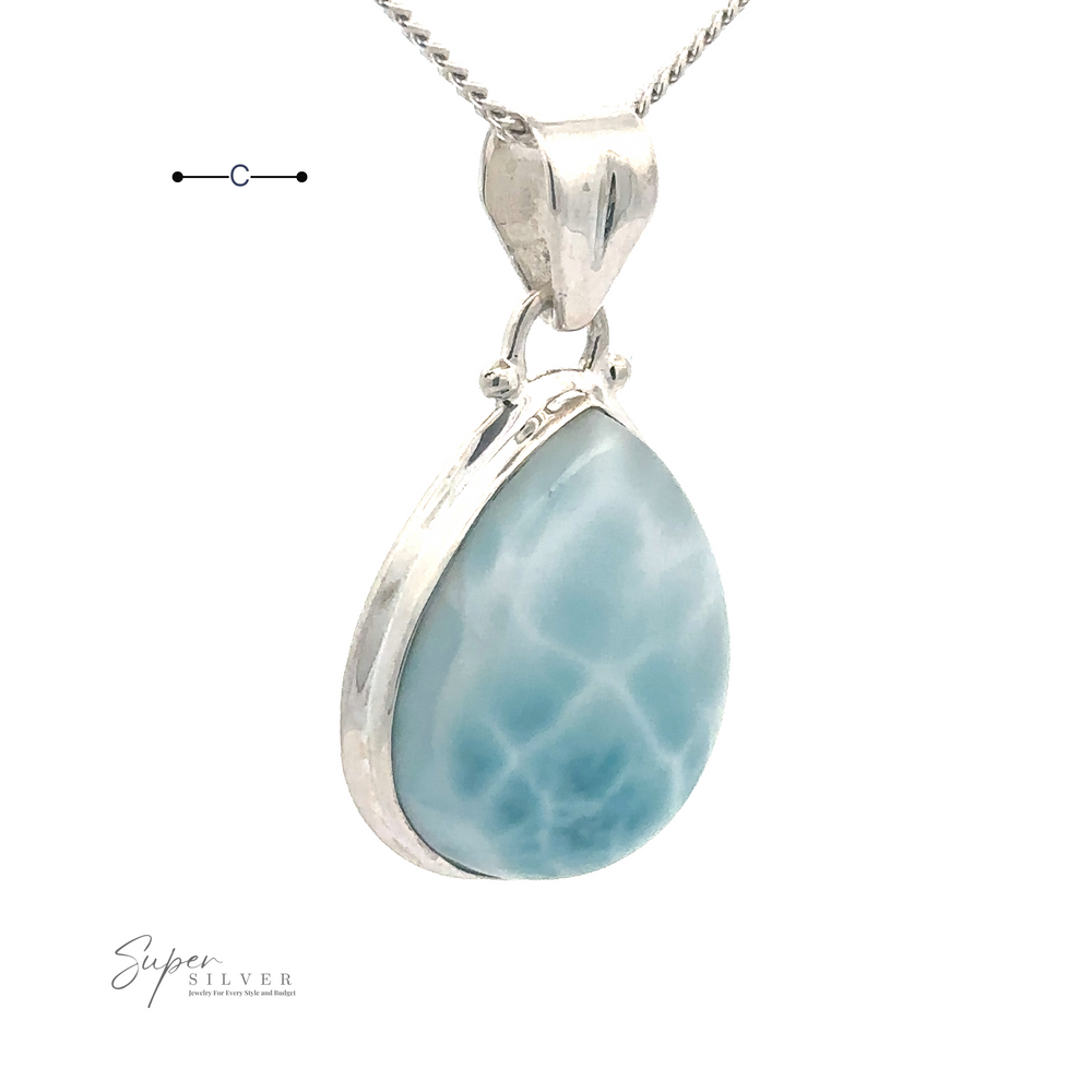 
                  
                    A Small Teardrop Larimar Pendant set in a sterling silver frame hangs from a silver chain, perfect for a night out. A small logo reading "Super Silver" is visible in the corner.
                  
                