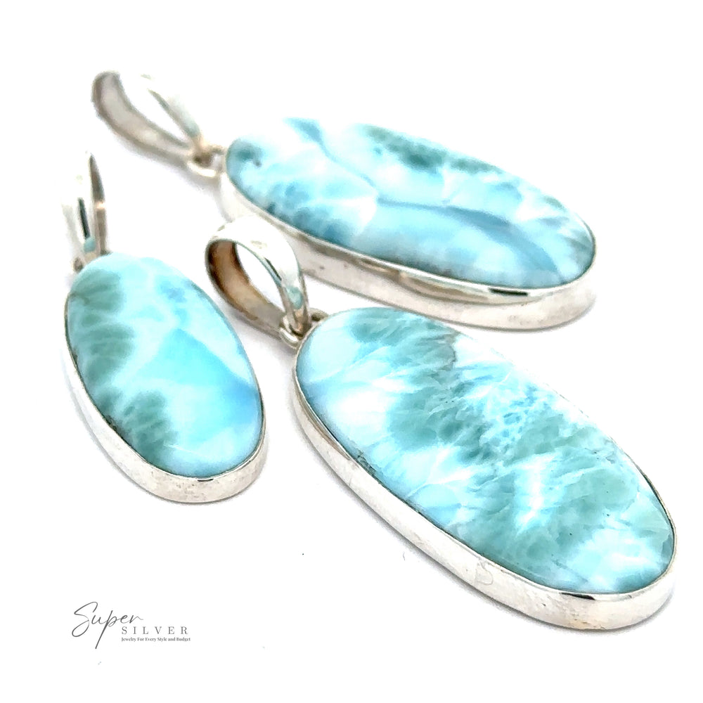 Three Beautiful Long Oval Larimar Pendants from the Dominican Republic are shown on a white background. The marbled Larimar stones add an exquisite touch. The text ".925 Sterling Silver" is visible in the bottom left corner alongside "Super Silver.