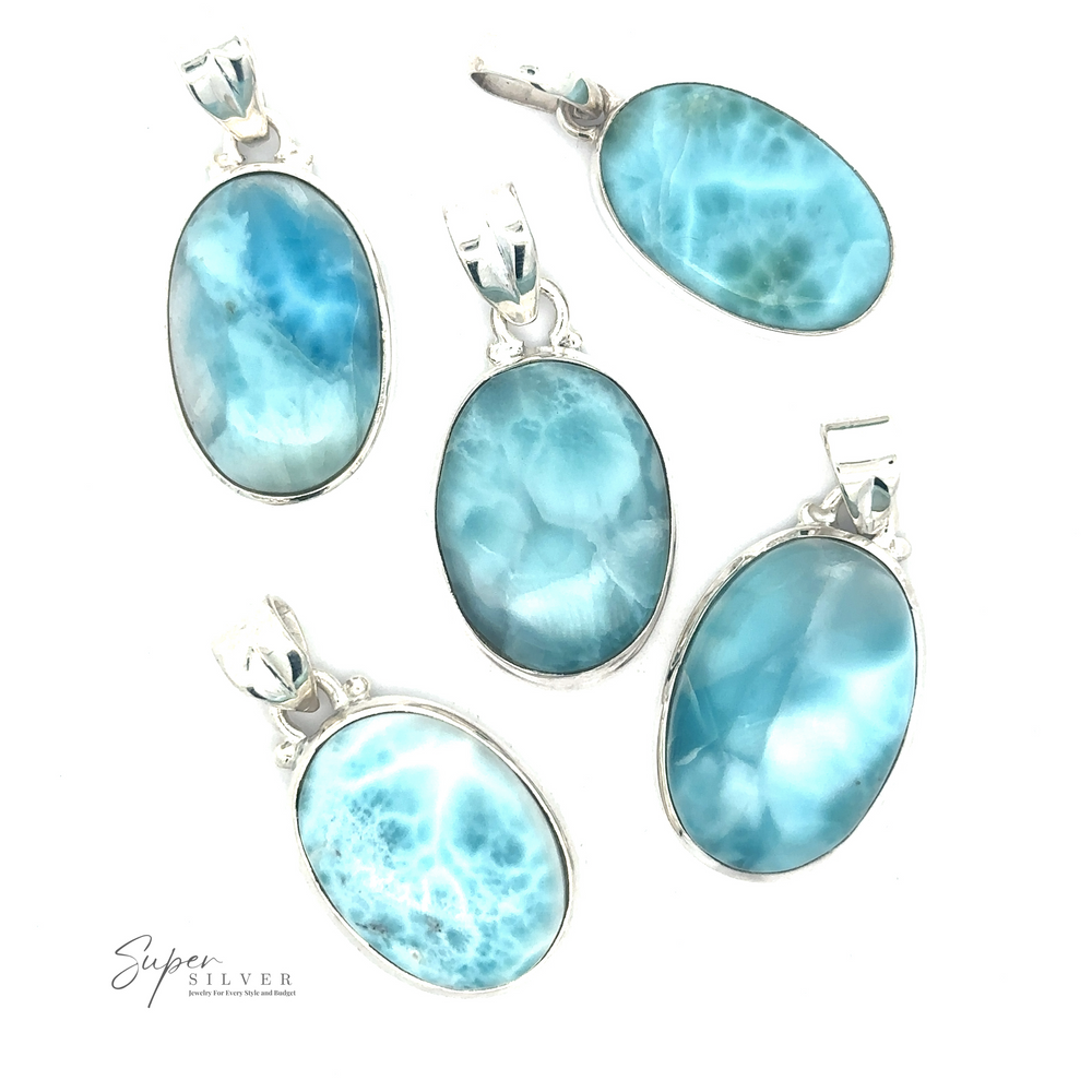 
                  
                    Five Small Oval Larimar Pendants featuring blue and turquoise oval stones, including beautiful Larimar, are arranged on a white background. Perfect for everyday wear, the logo "Super Silver" is visible in the bottom left corner.
                  
                