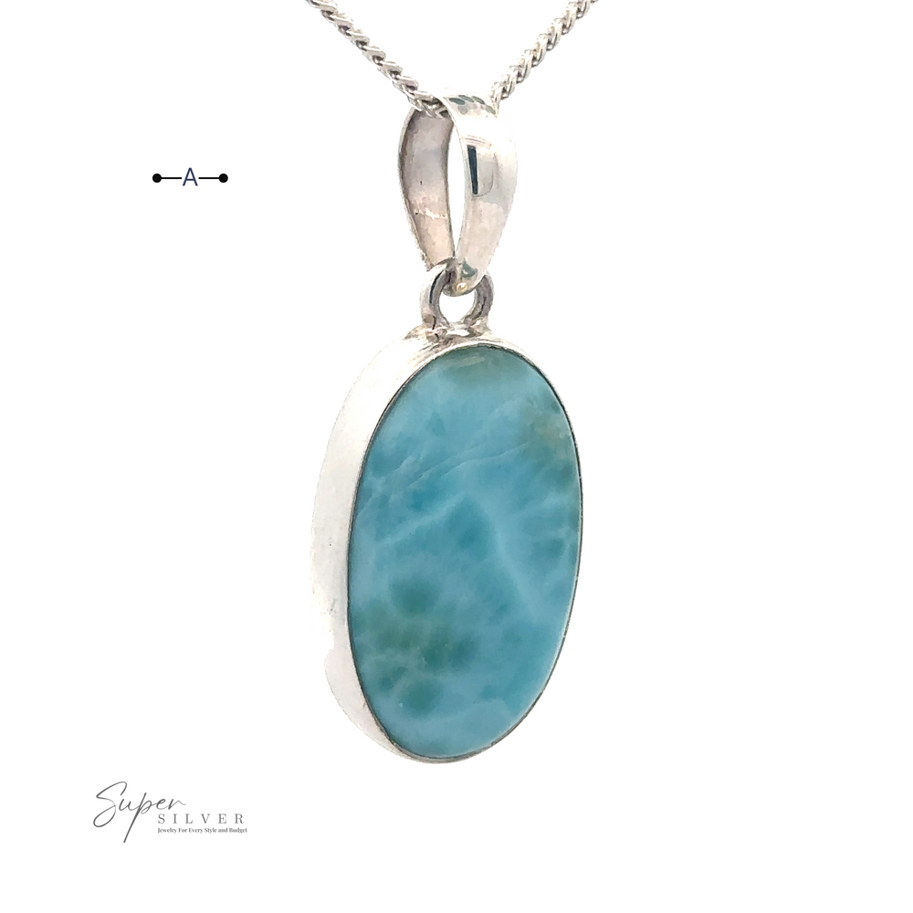 
                  
                    A Small Oval Larimar Pendants featuring an oval blue Larimar gemstone. The background is white and includes a logo in the bottom left corner and a scale indicating 1 cm at the top left, perfect for everyday wear.
                  
                