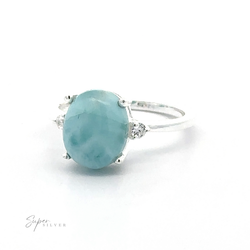 
                  
                    Silver ring with a large Brilliant Pronged Oval Turquoise Gemstone Ring in a prong setting, flanked by small diamonds, displayed against a white background.
                  
                