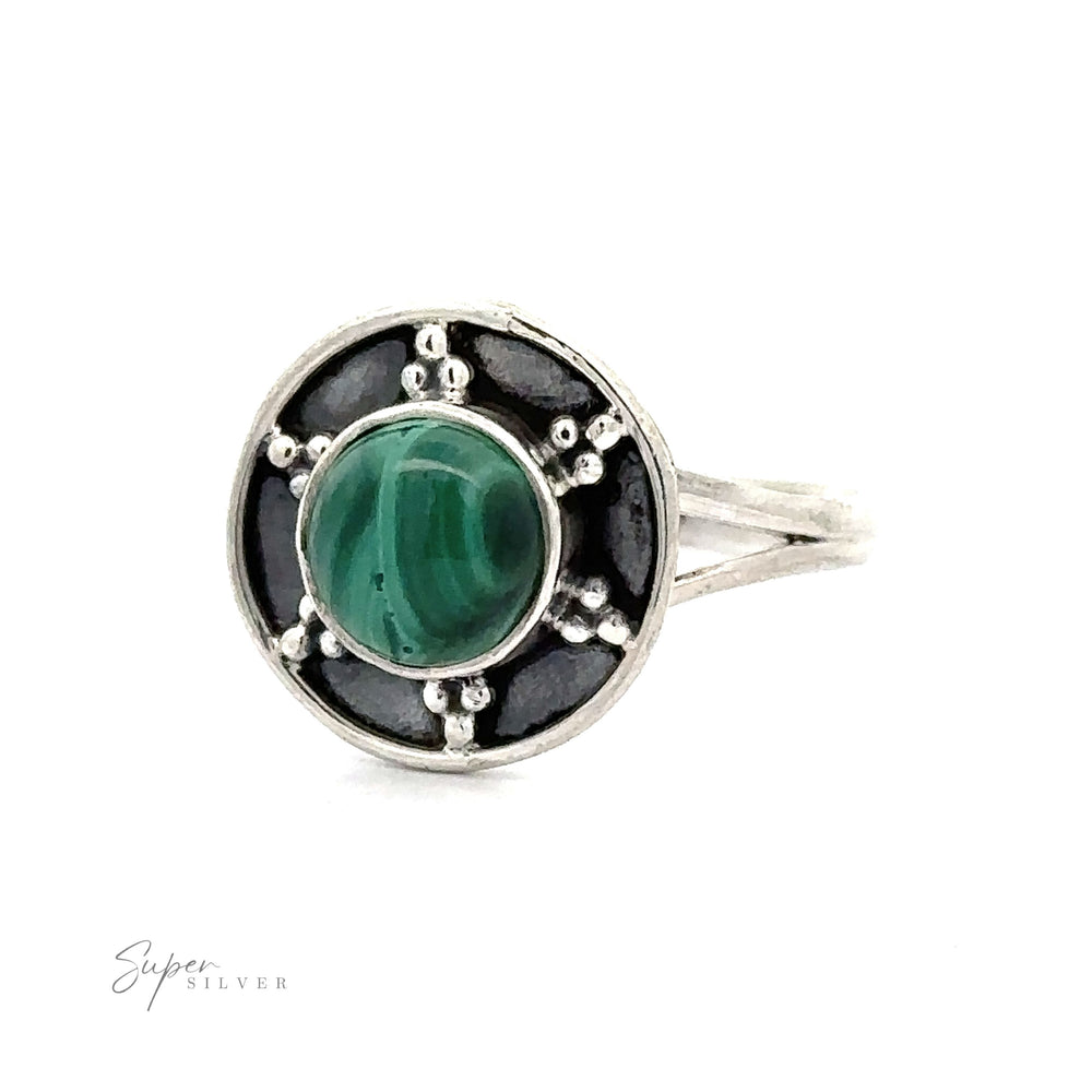 
                  
                    A Gemstone Ring With Unique Oxidized Design featuring a round green gemstone set in a circular pattern with black and oxidized silver accents, exemplifying exquisite Gemstone Jewelry.
                  
                
