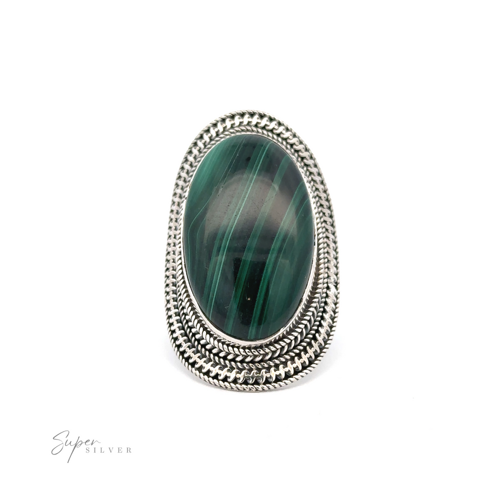
                  
                    A Large Oval Shield Gemstone Ring featuring a large, oval green gemstone with dark green streaks set in an ornate, braided silver band design. The background is white with "Super Silver" inscribed at the bottom left, giving it a touch of bohemian flair.
                  
                