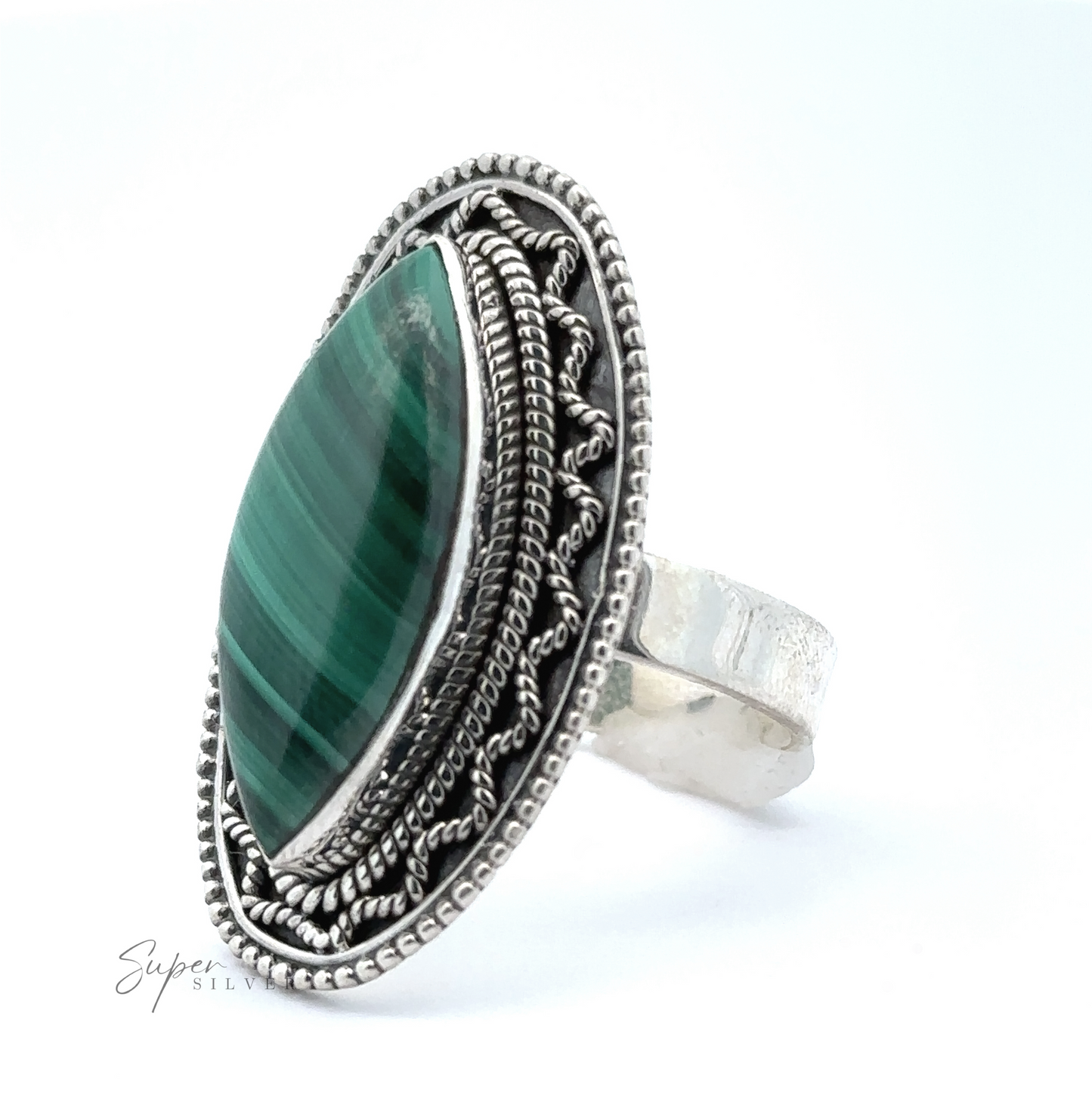 
                  
                    Marquise Shaped Gemstone Ring With Vintage Shield Border with intricate detailing, featuring a large marquise-cut green stone in the center, giving it a Bohemian twist.
                  
                