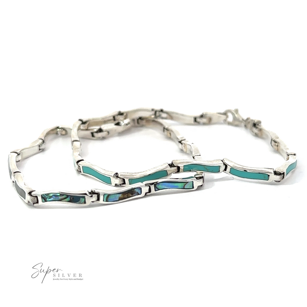 
                  
                    Three silver bracelets with rectangular turquoise inlays, displayed side by side against a white background. Each Inlay Stone Curved Shaped Bracelet showcases the captivating hue of turquoise. The logo "Super Silver" is visible in the bottom left corner.
                  
                