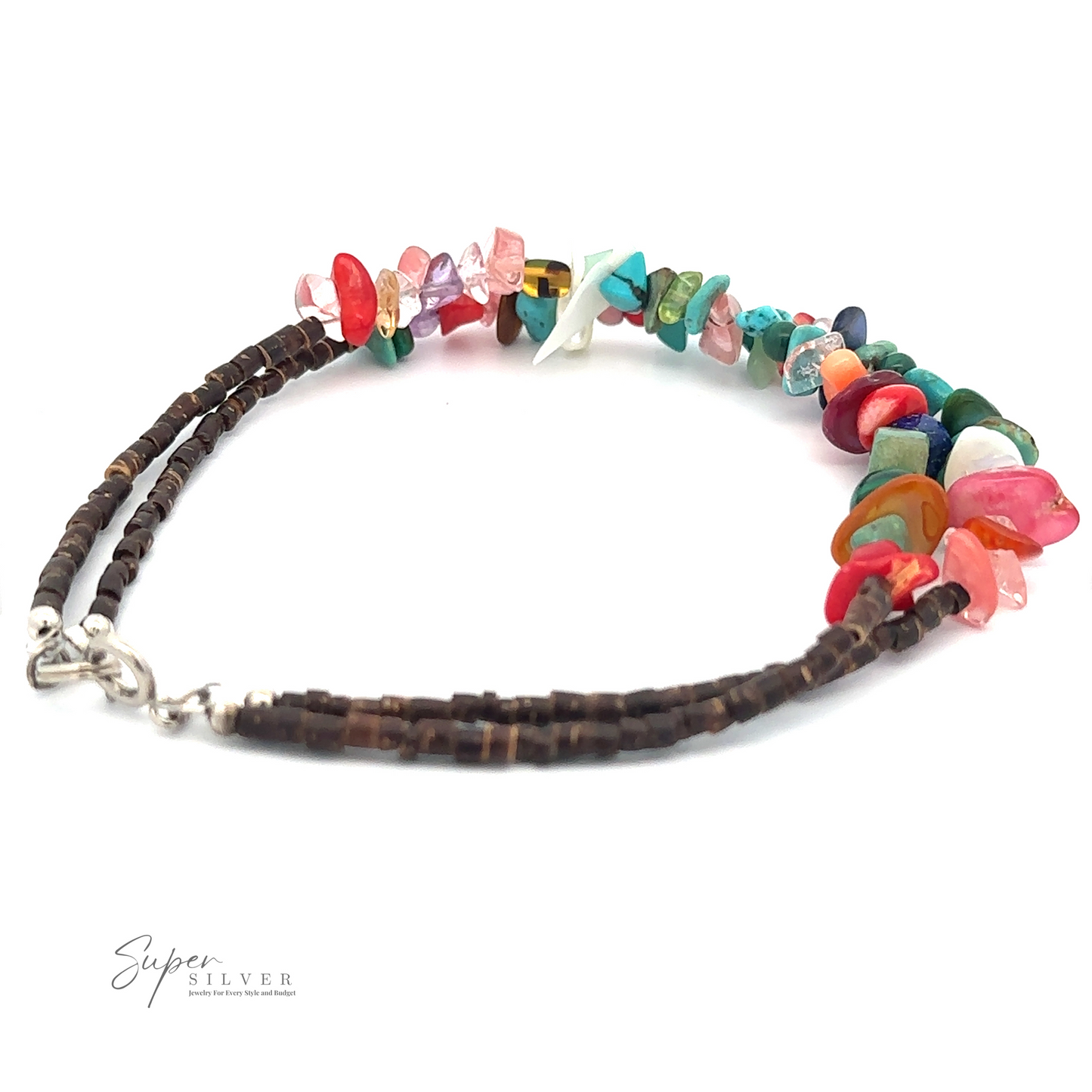 
                  
                    A Colorful Southwest Beaded Stone Anklet with a silver clasp, exuding bohemian charm, is placed on a white background. The irregularly shaped gemstones are strung alternately with small dark beads, creating an eclectic and vibrant accessory.
                  
                