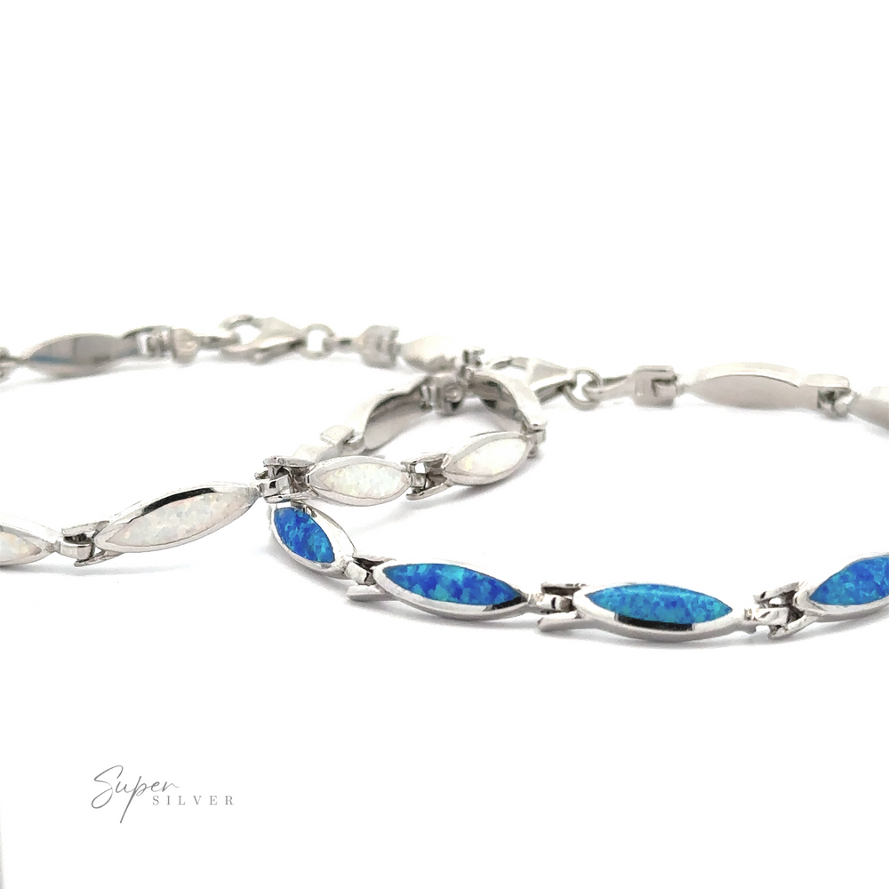 Two .925 Sterling Silver bracelets, one featuring white lab-created opal inlays and the other adorned with blue opal inlays, displayed on a white background. The modern design of the Marquise Shaped Lab-Created Opal Bracelet is branded "Super Silver.