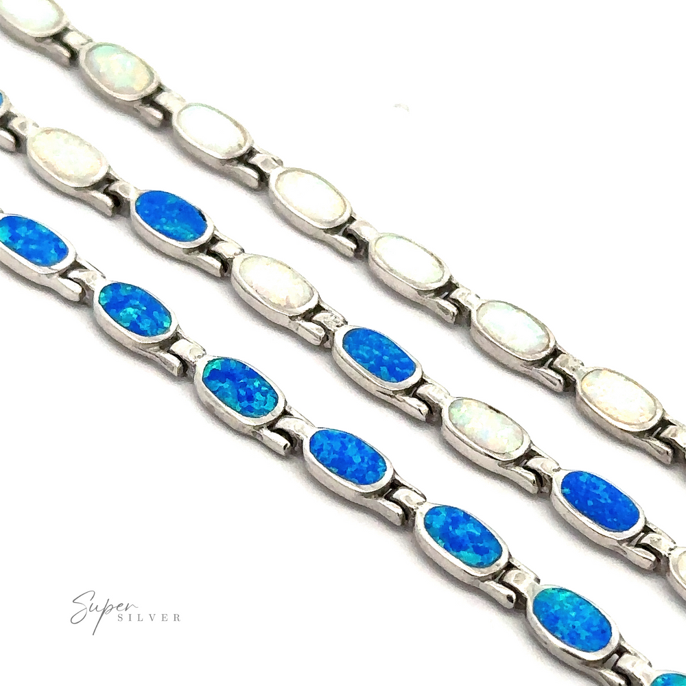 Three Oval Lab-Created Opal Bracelets, crafted from .925 sterling silver and featuring insets of lab-created opals in varying shades of blue and white, are displayed in parallel rows on a white background, exuding modern elegance.