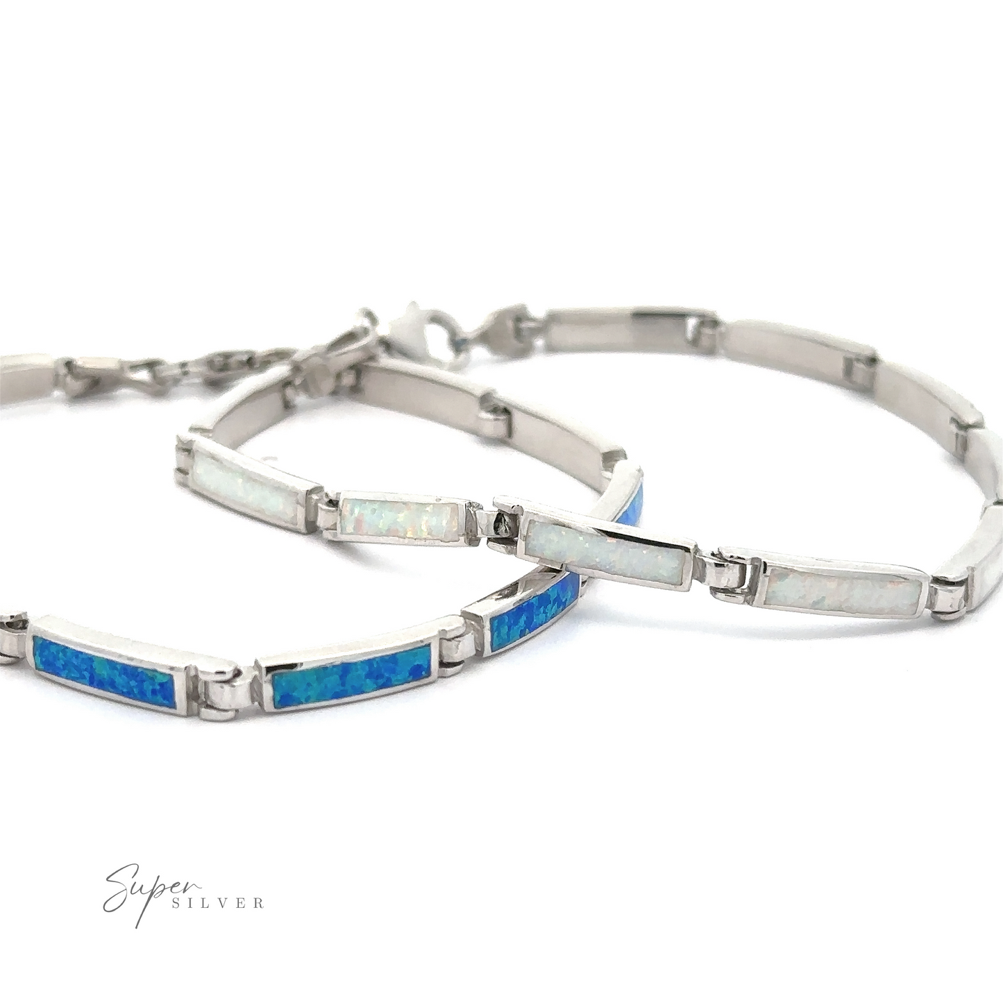 A pair of Long Rectangle Lab-Created Opal Bracelets with stunning blue and white opal inlays are displayed side by side on a white background, showcasing the exquisite Opal Glow Jewelry.