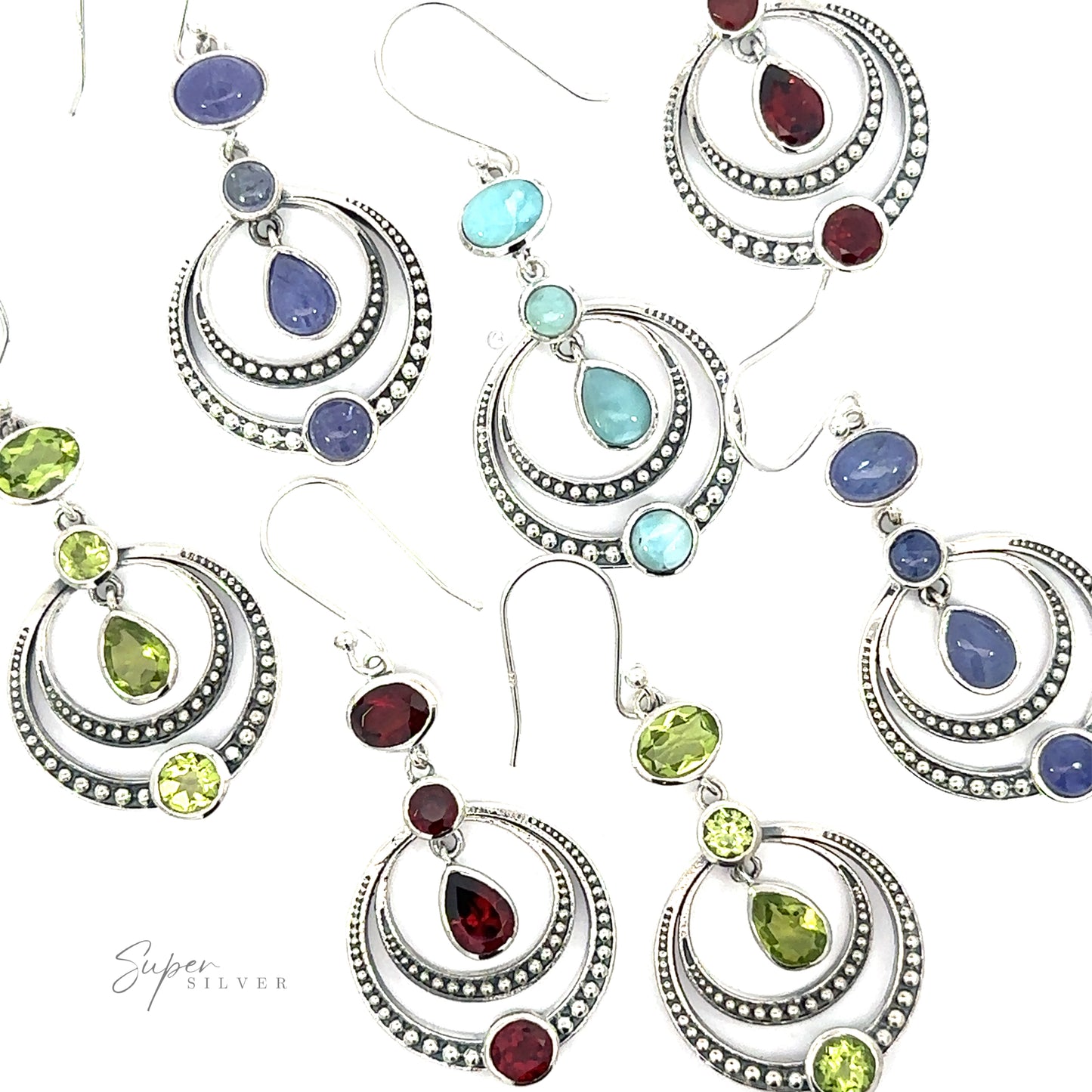 A collection of Overlapping Circle Earrings with Vibrant Gemstones, each adorned with different colored stones including purple, blue, red, and green, arranged on a white background.