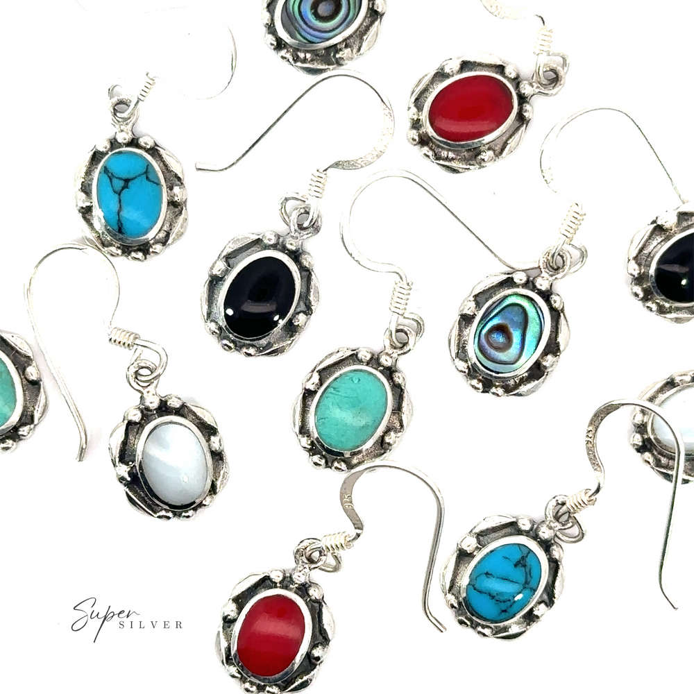 A group of Oval Inlaid Stone Earrings featuring inlaid stones on a white background.
