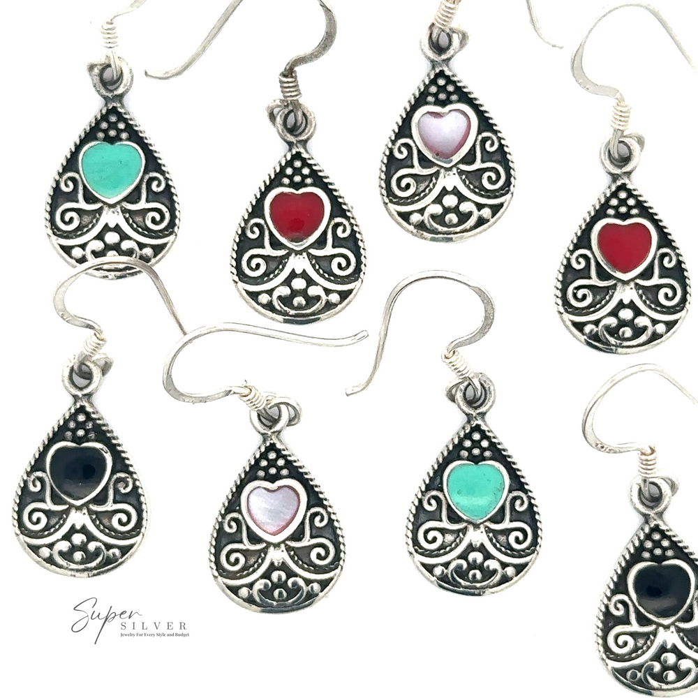 A collection of nine intricate Bali Style Teardrop Earrings with Inlaid Stone in various colors. The earrings feature ornate sterling silver details and dangle hooks. Logo reads 