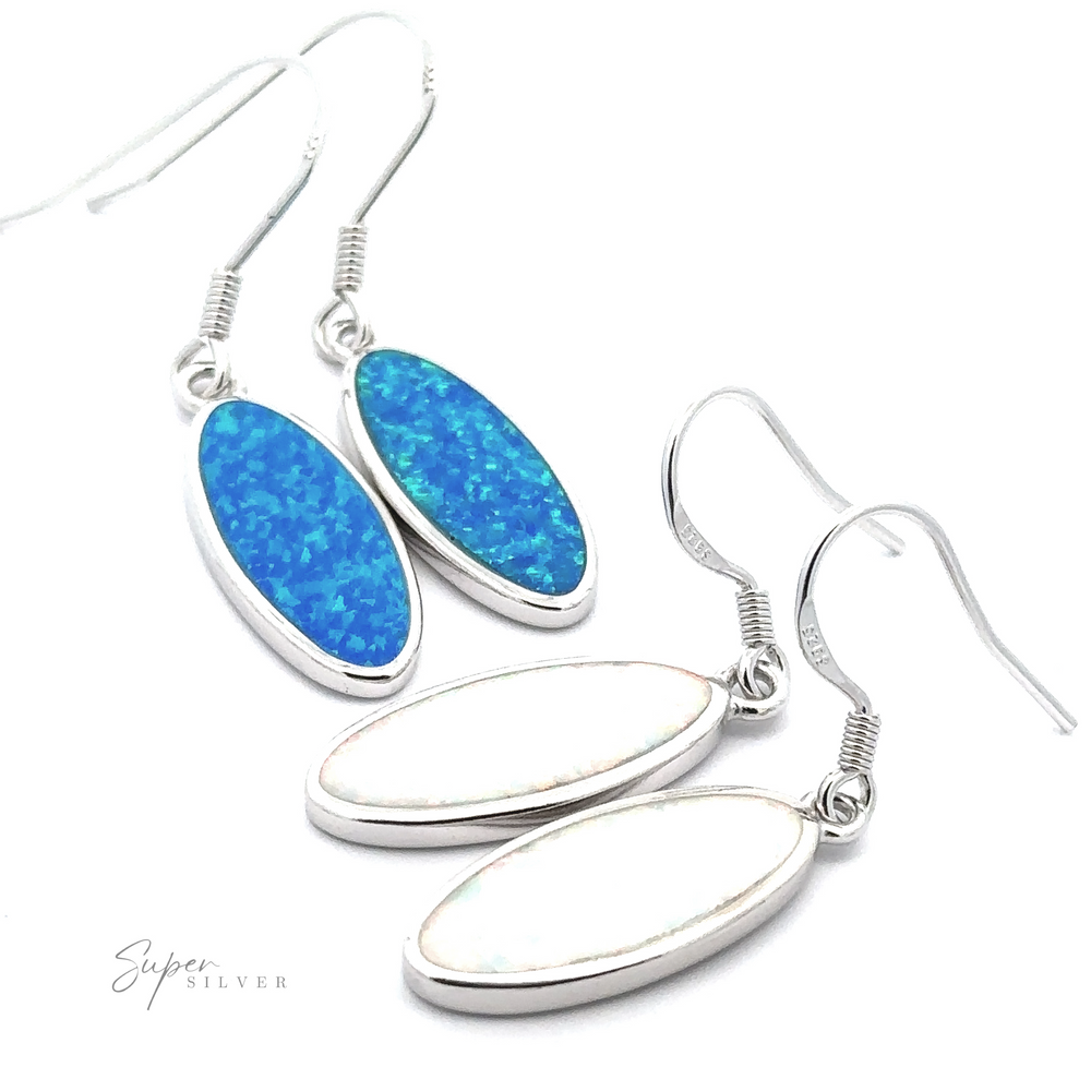 The Simple Oval Lab-Created Opal Earrings come in two pairs: one pair features stunning blue opals, while the other showcases beautiful lab-created white opal stones. Both pairs are set in elegant silver frames with hook fastenings.