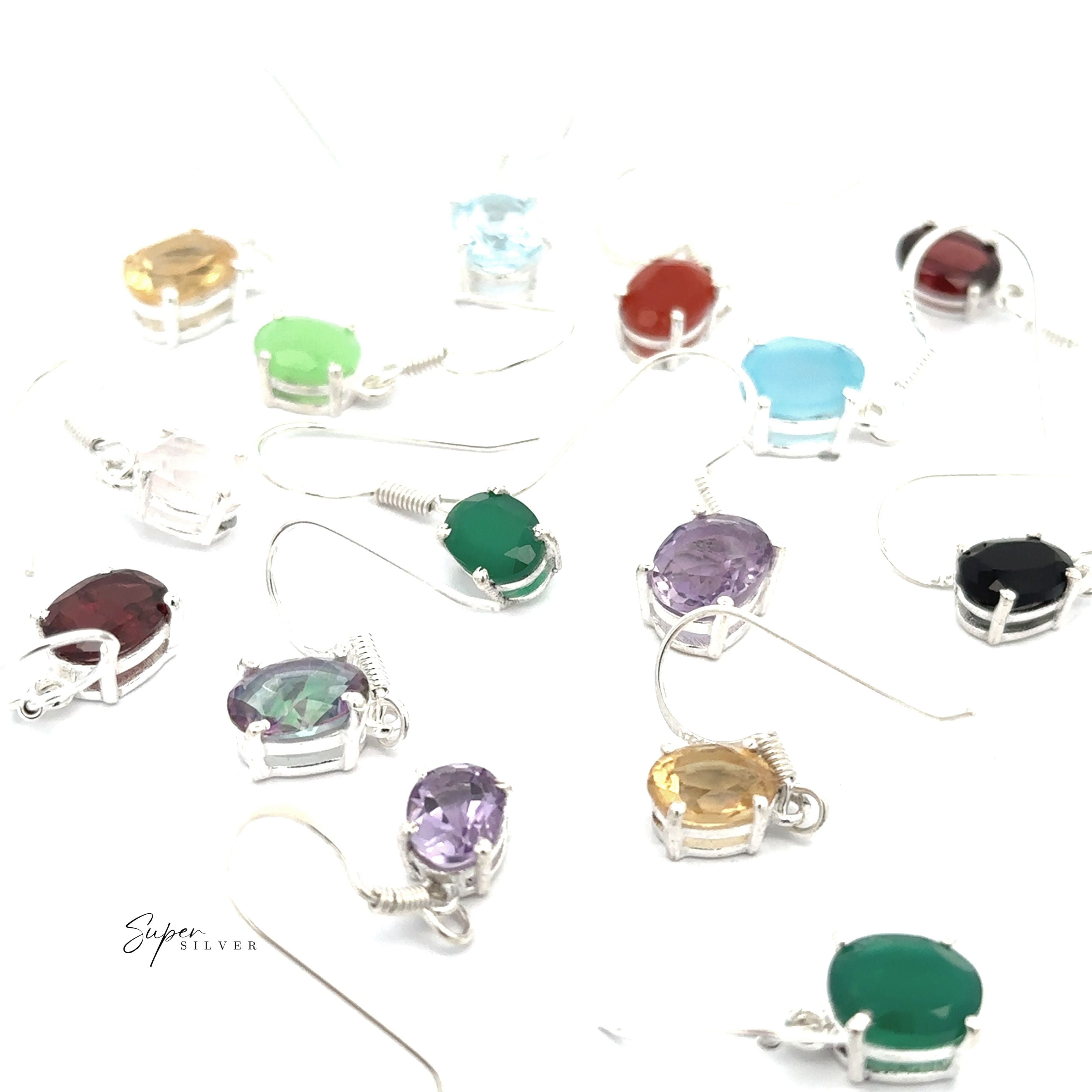 A collection of Brilliant Oval Gemstone Earrings, crafted in sterling silver with prong-set oval charms in assorted colors, displayed on a white background.