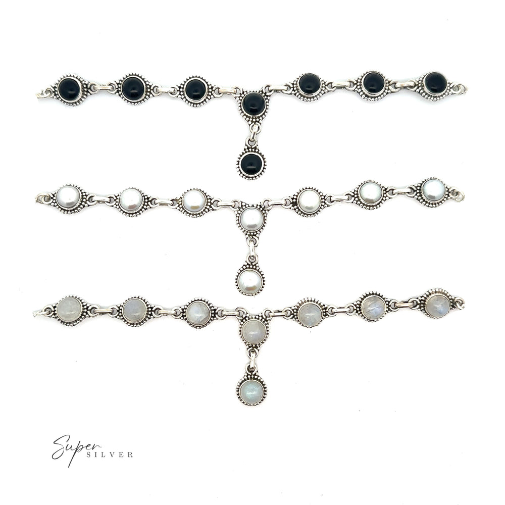
                  
                    Three Round Gemstone Y Necklaces with Ball Border are displayed horizontally on a white background, embodying bohemian style jewelry. The first necklace features black stones, the second showcases white stones, and the third has gray stones.
                  
                