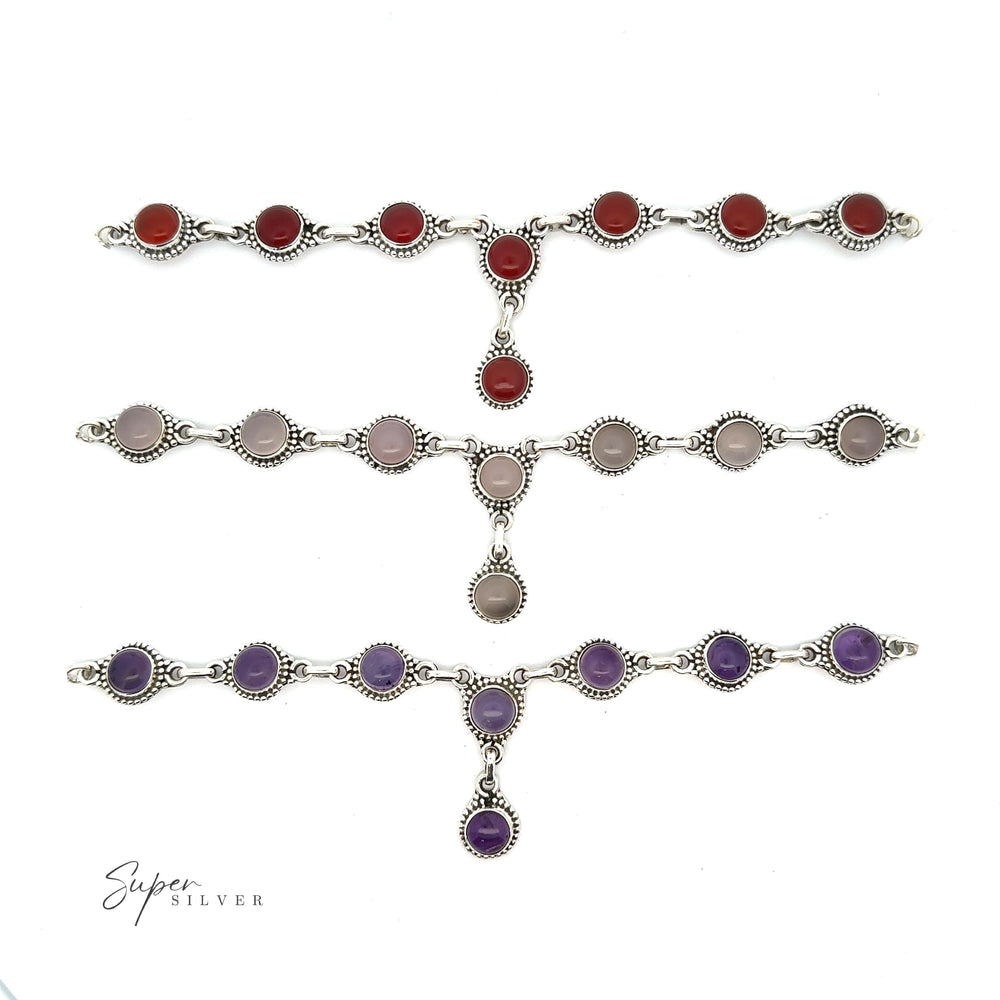 Three silver bracelets with round, colored stones in red, gray, and purple are laid out horizontally on a white background. The logo "Super Silver" is visible in the bottom left corner. This bohemian style jewelry complements any Round Gemstone Y Necklace with Ball Border for a chic look.