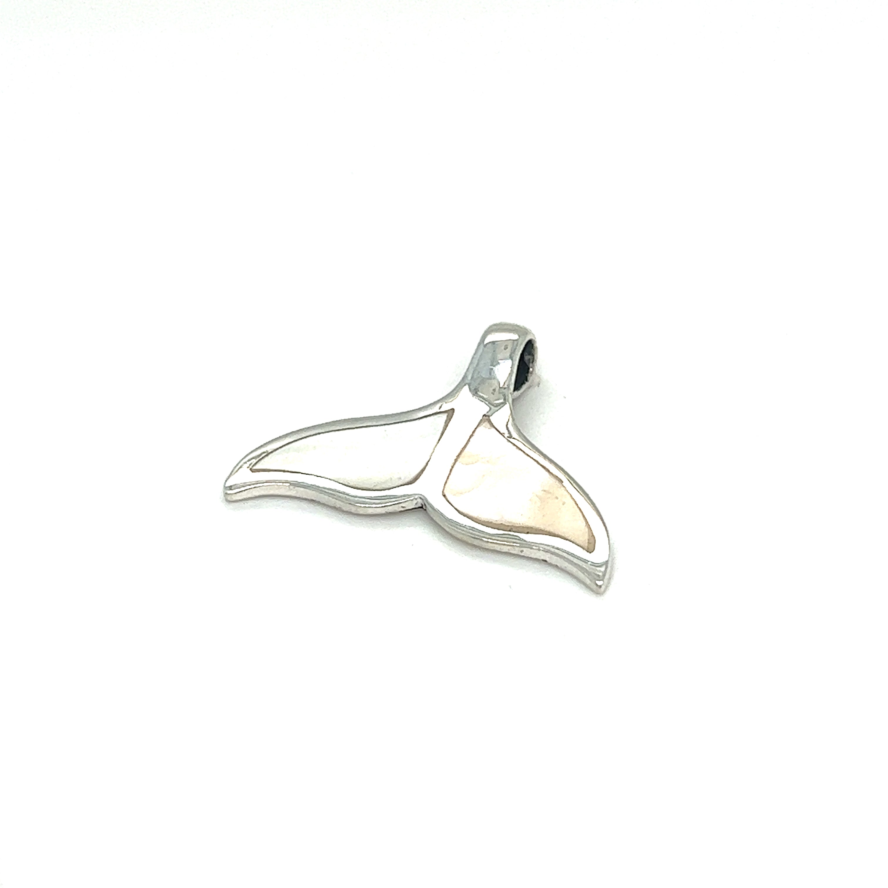 A Super Silver inlay whale tail pendant on a white background in Santa Cruz.