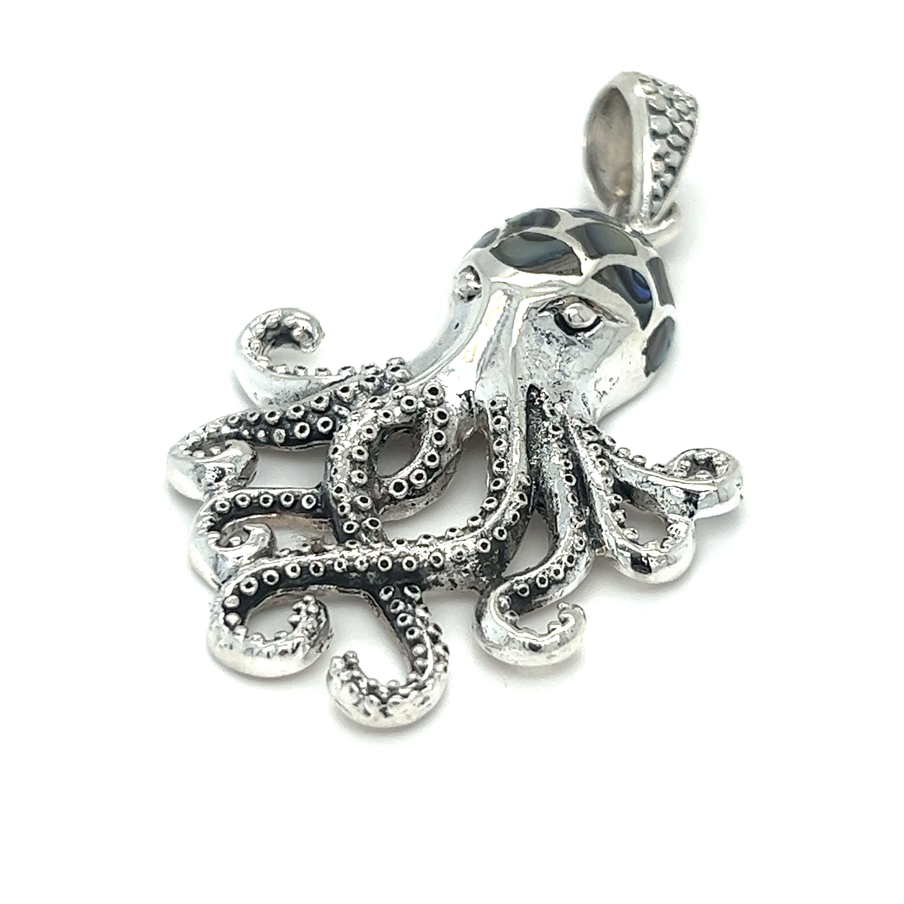 A symbolically intricate Super Silver octopus pendant with inlay stone details, crafted in sterling silver.